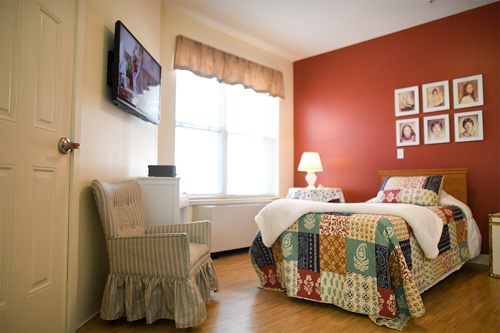 Cozy private room with a bed and chair
