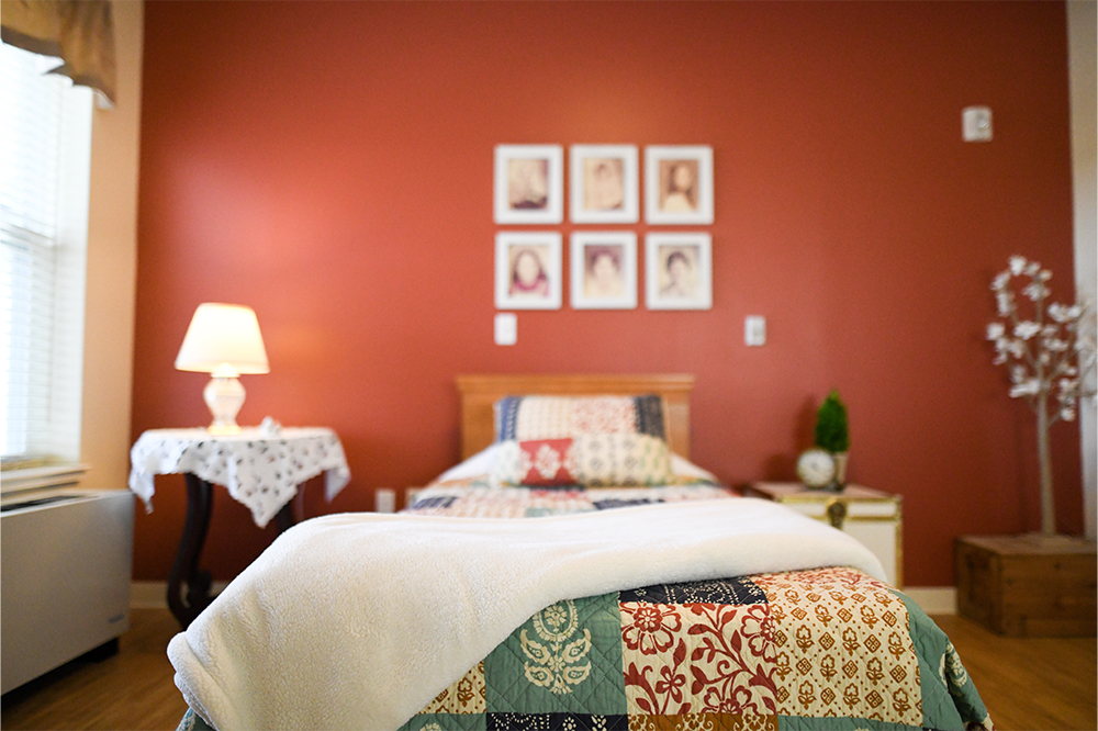Cozy resident room with quilt and personal touches