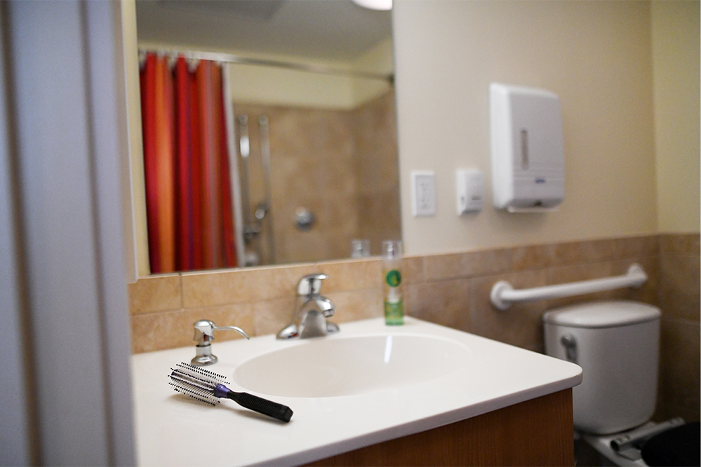 Bathroom sink with toiletries and comb