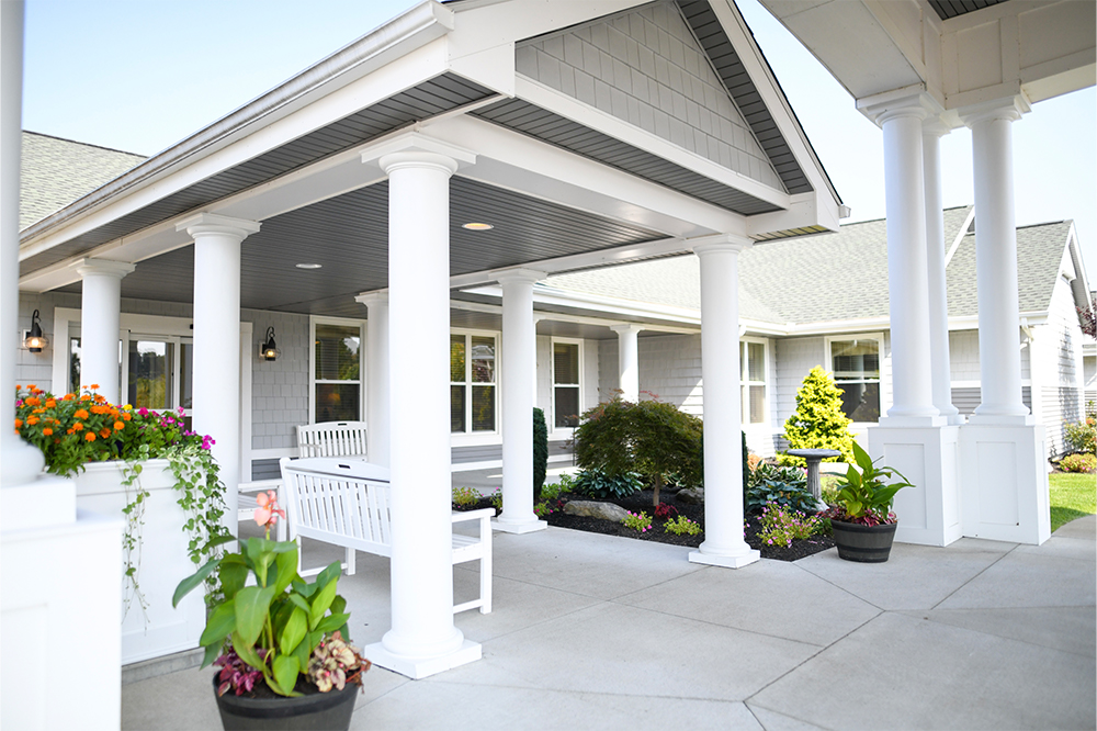 A welcoming entrance with flowers and seating