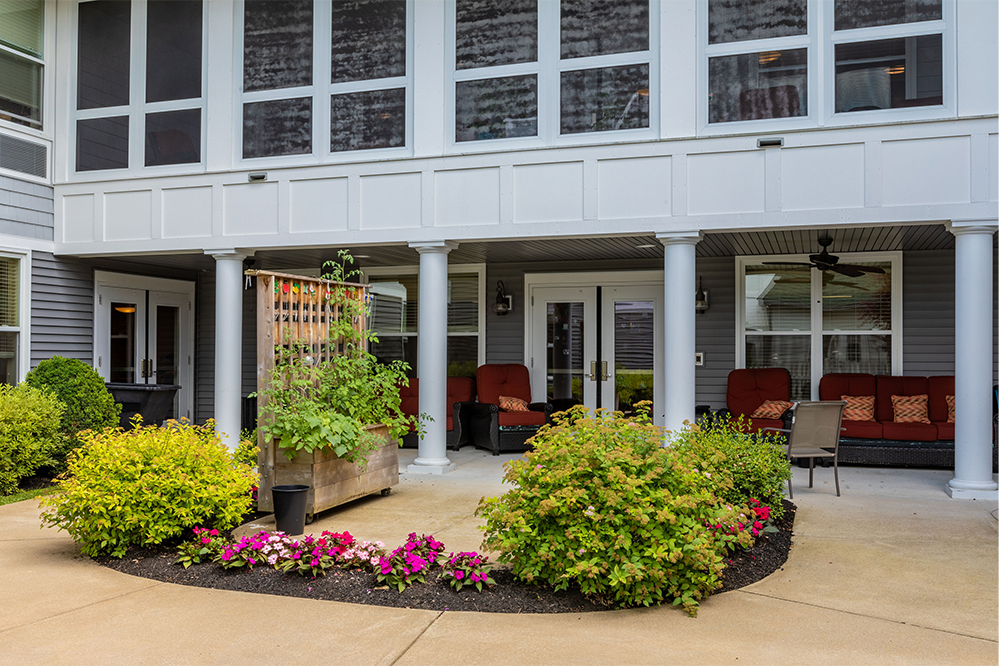 Outdoor lounge area with flowers and seating