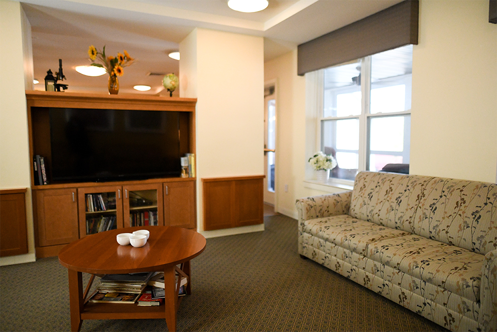 Bright lounge area with a couch and TV