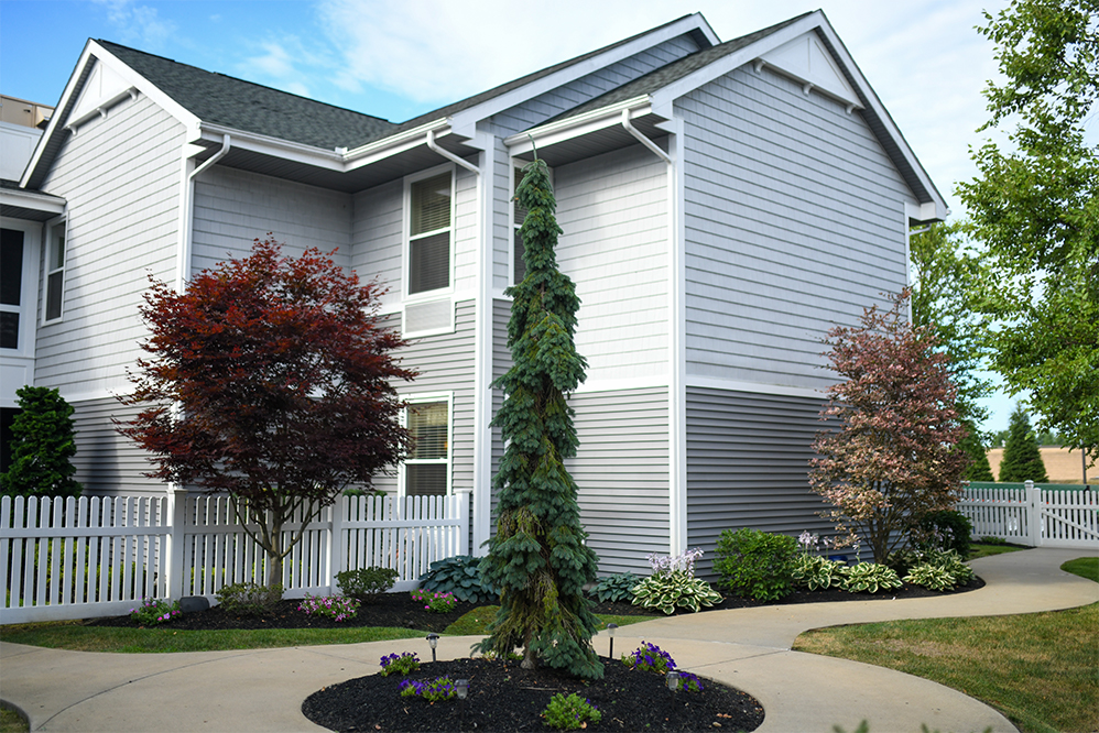 Exterior view of a senior living facility with landscaping