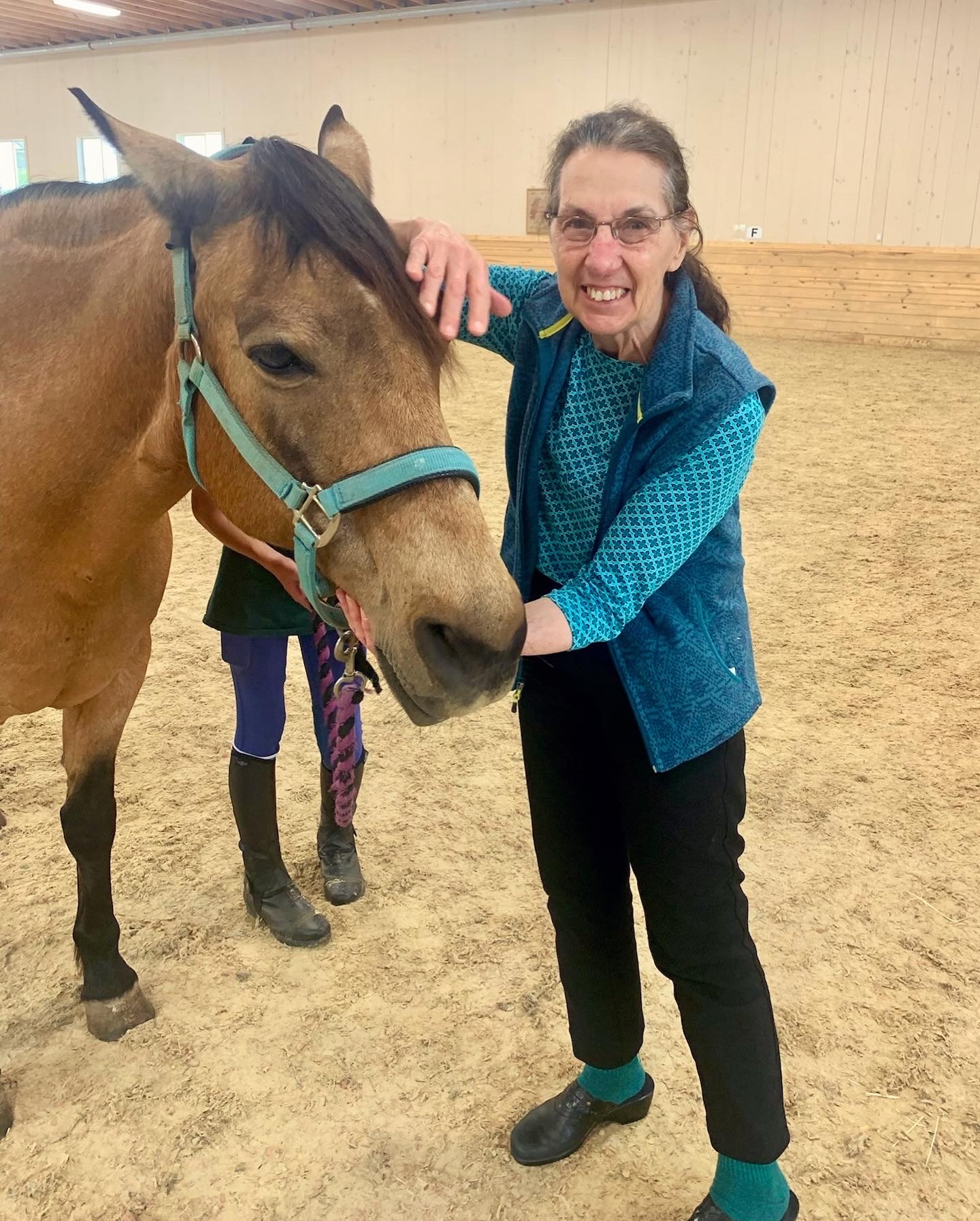 A resident interacting with a horse during a therapy session