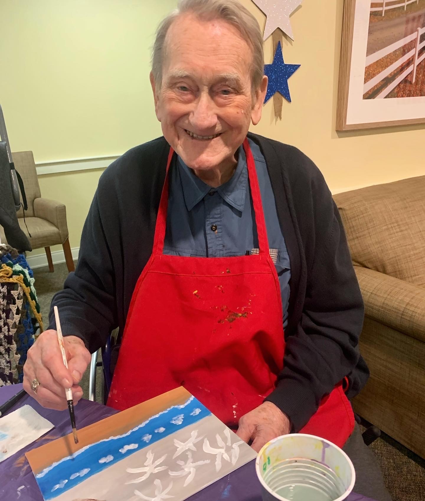Resident painting in an activity room