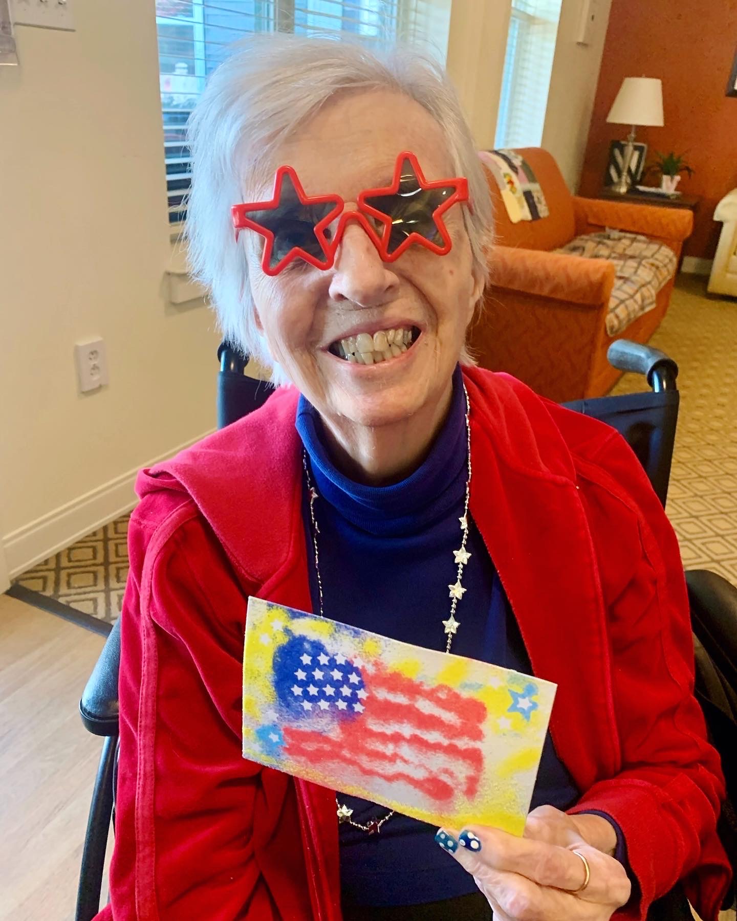 Resident celebrating with a painted flag art project