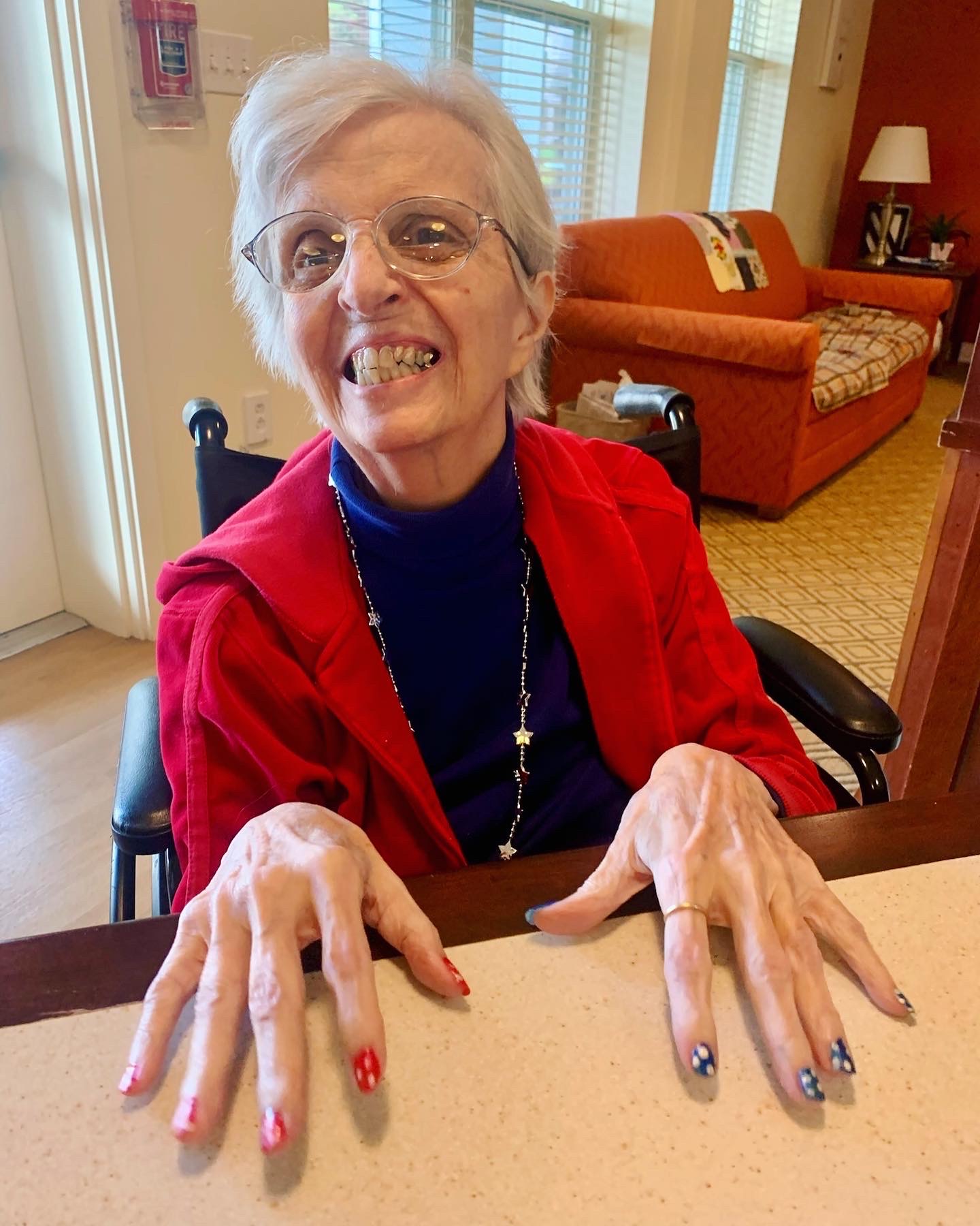 Senior resident smiling at a table