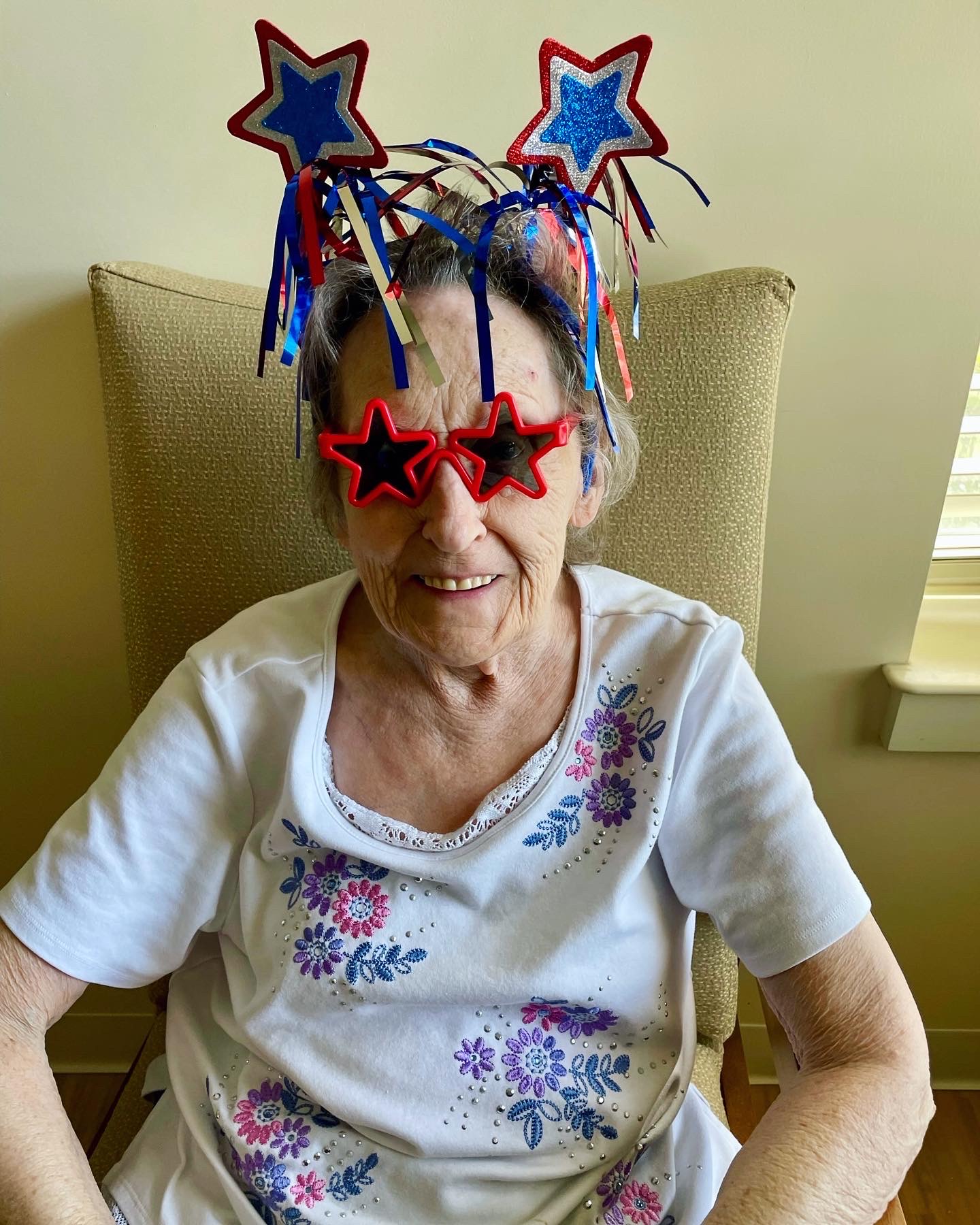 Resident celebrating with festive accessories and glasses