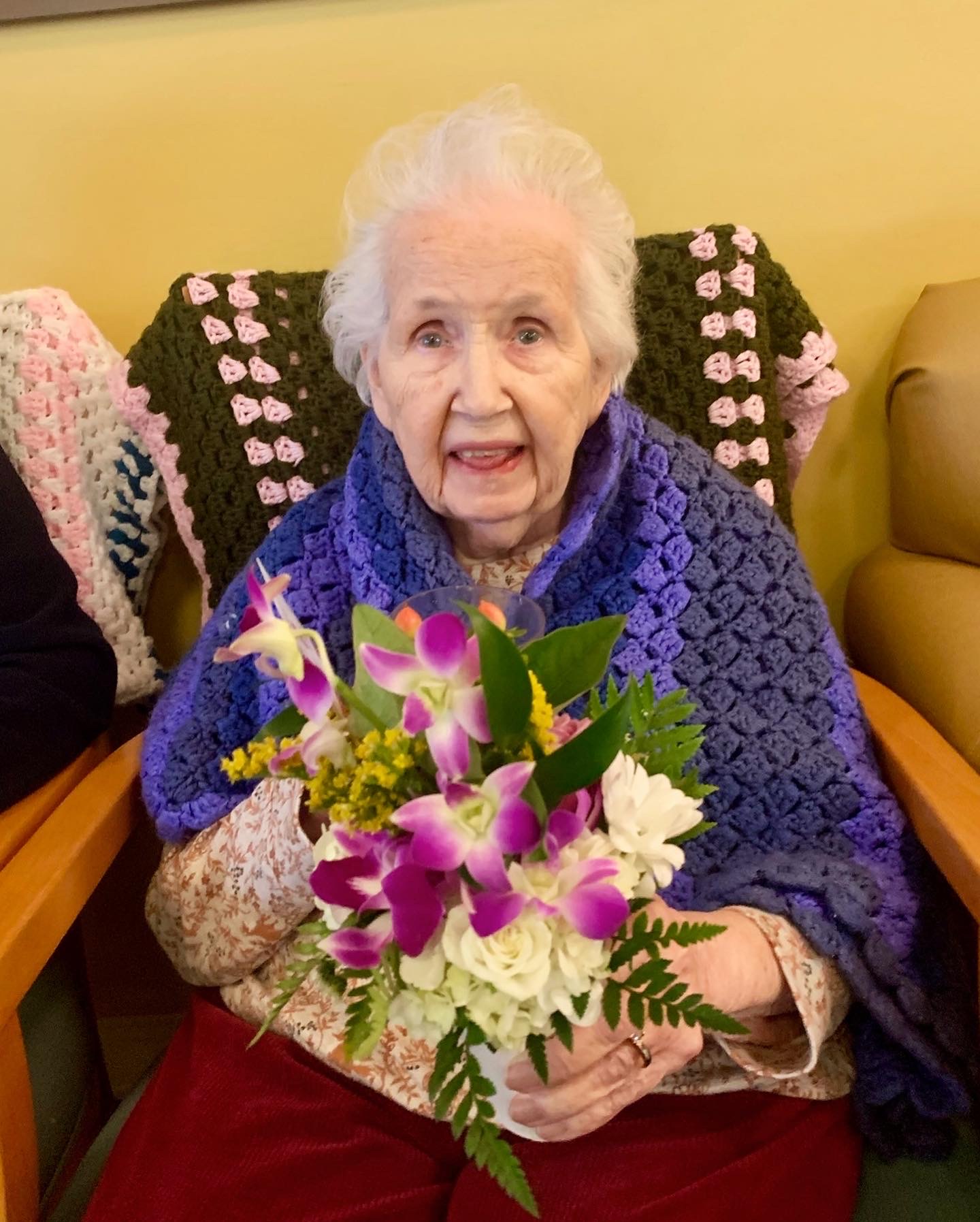 Senior resident holding a bouquet of flowers