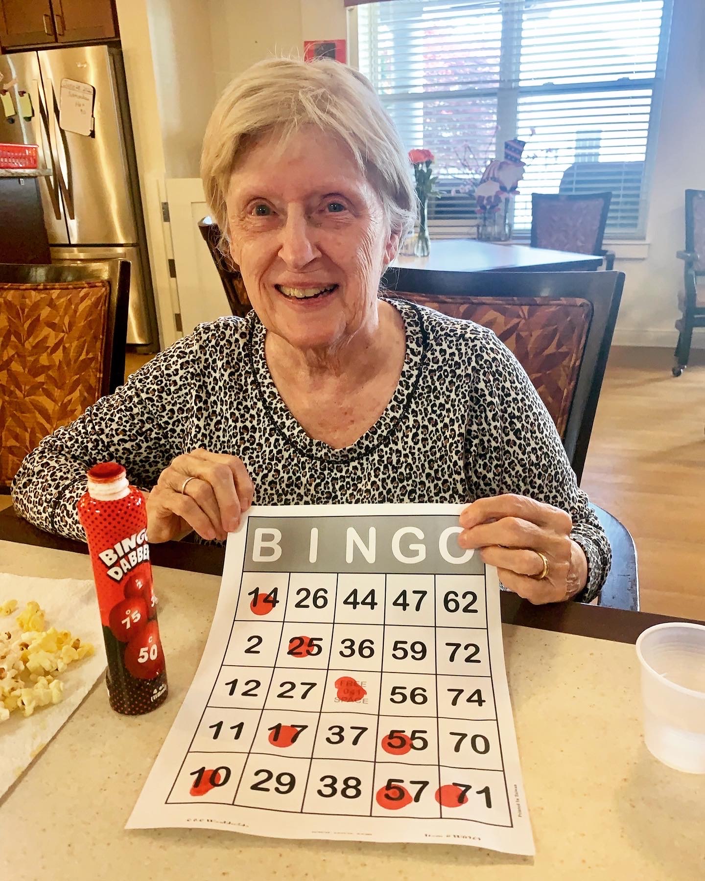 Resident playing bingo in a bright activity room