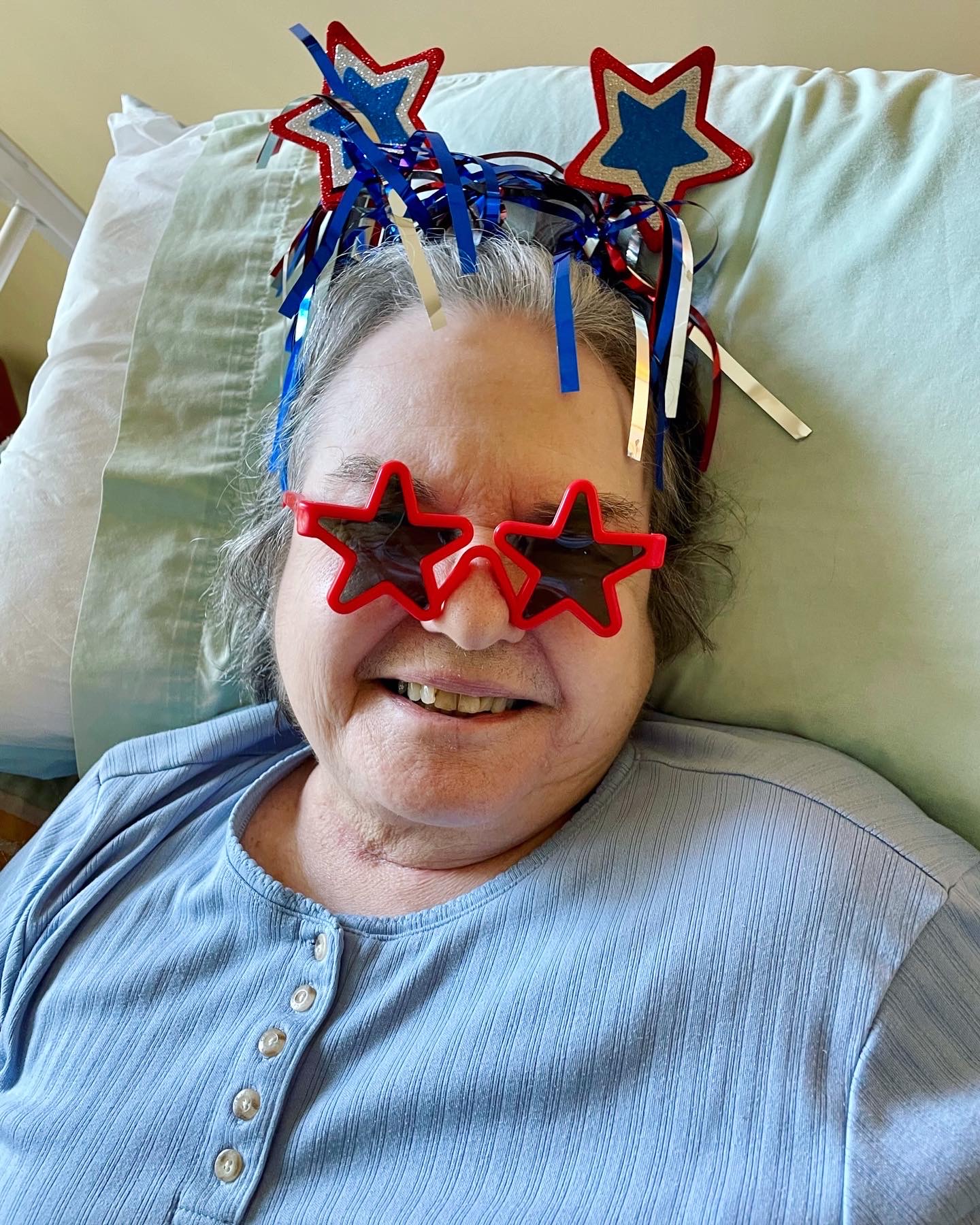 Resident celebrating with festive attire and glasses