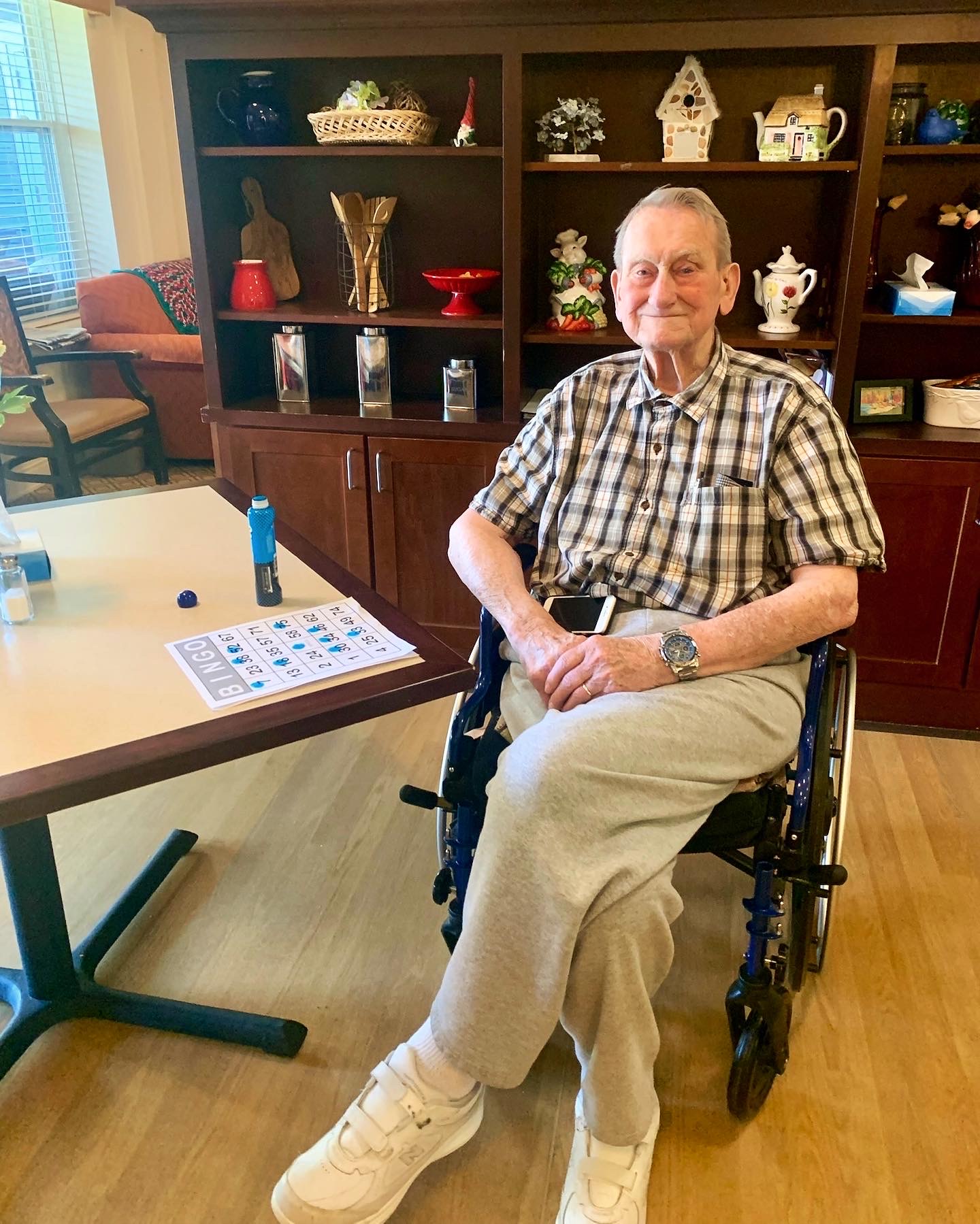 Senior resident playing bingo in a common area