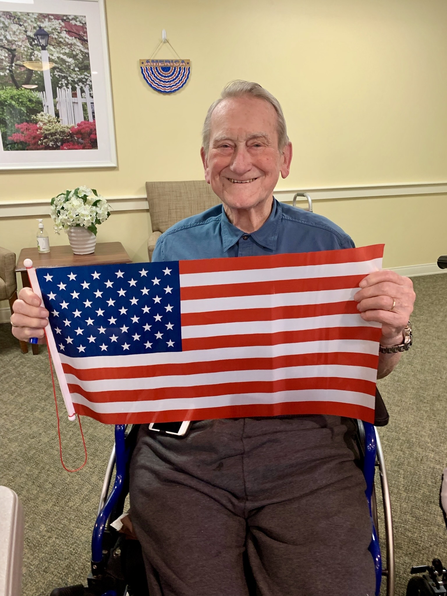 Resident holding a flag in a common area