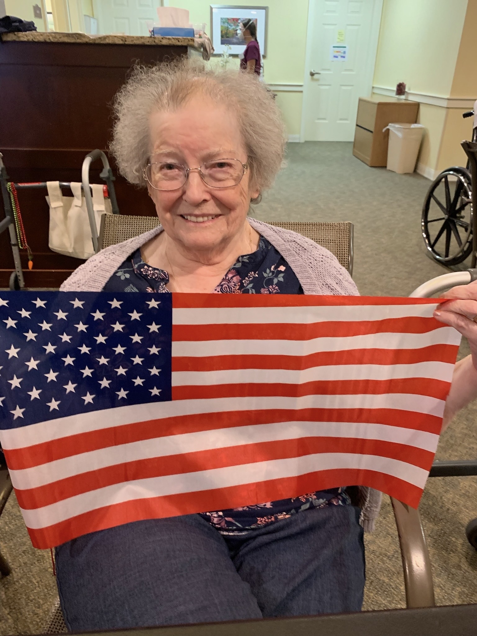 Resident holding an American flag in a common area