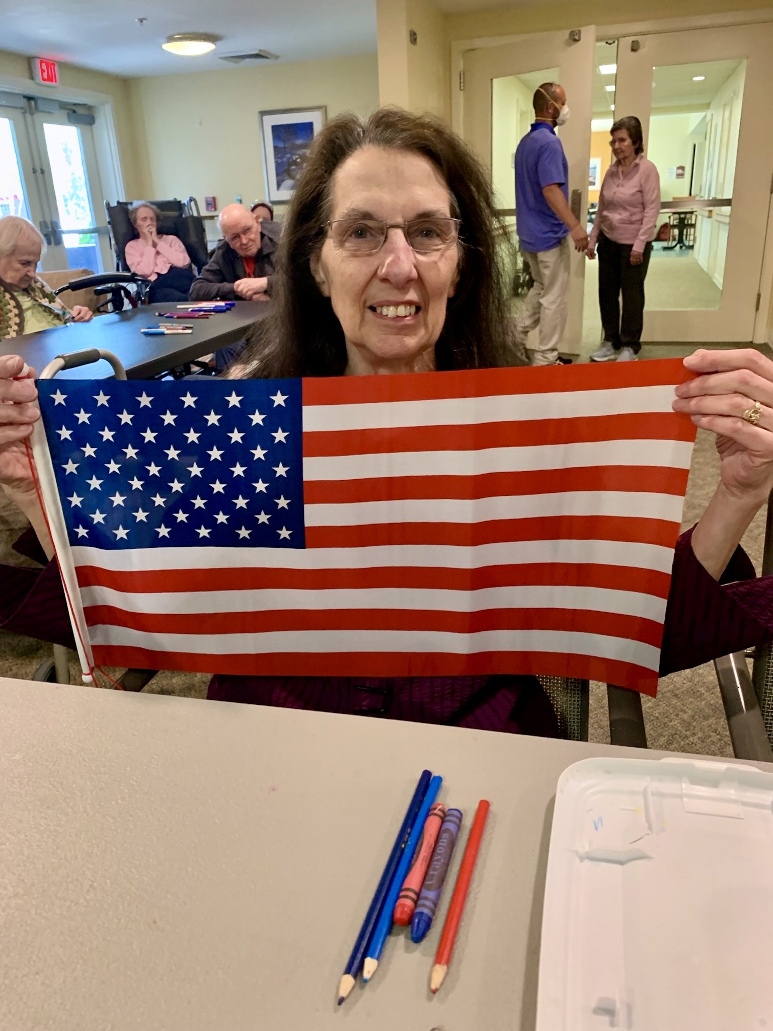 Resident holding an American flag during an activity