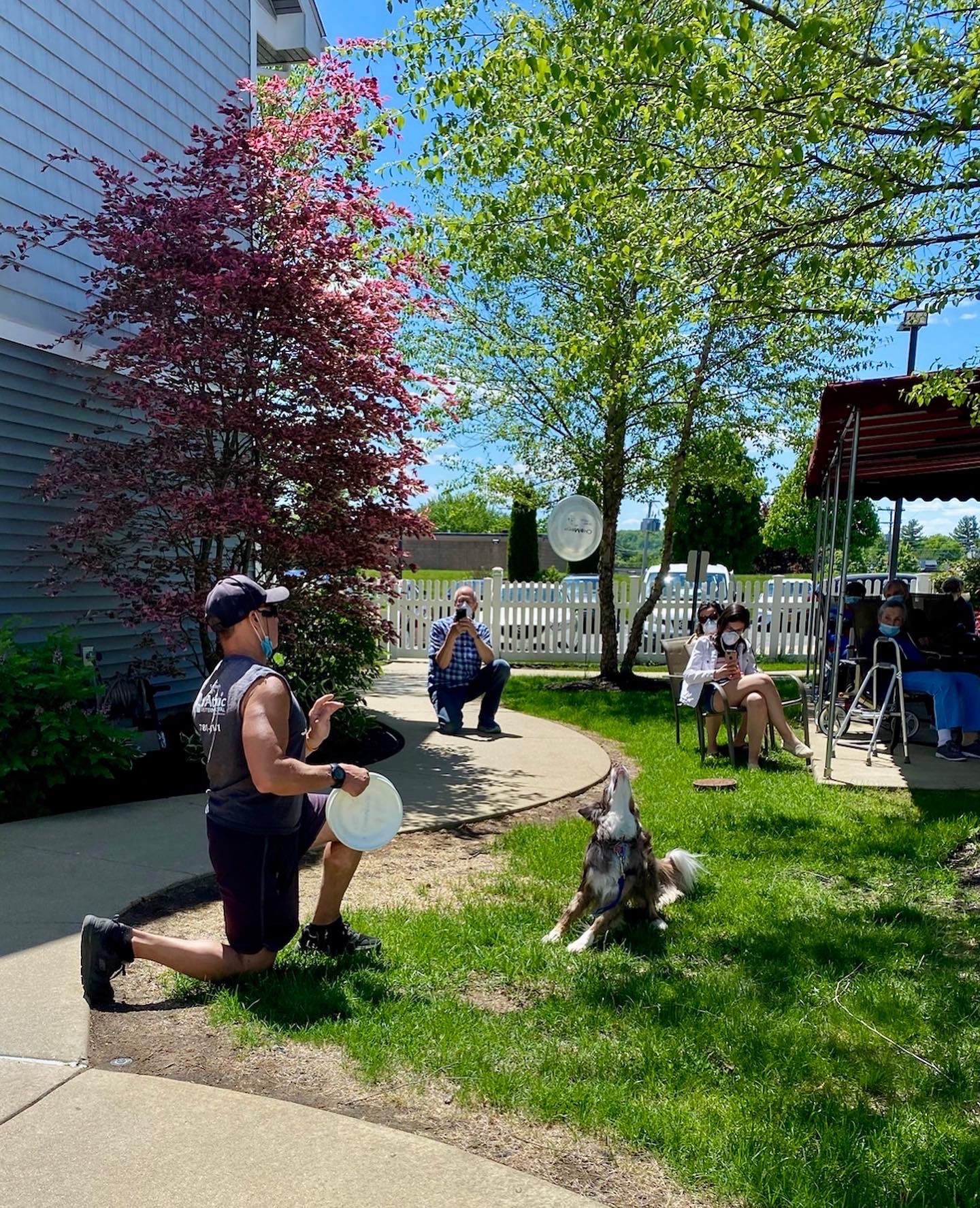 Residents enjoying outdoor activities with a dog