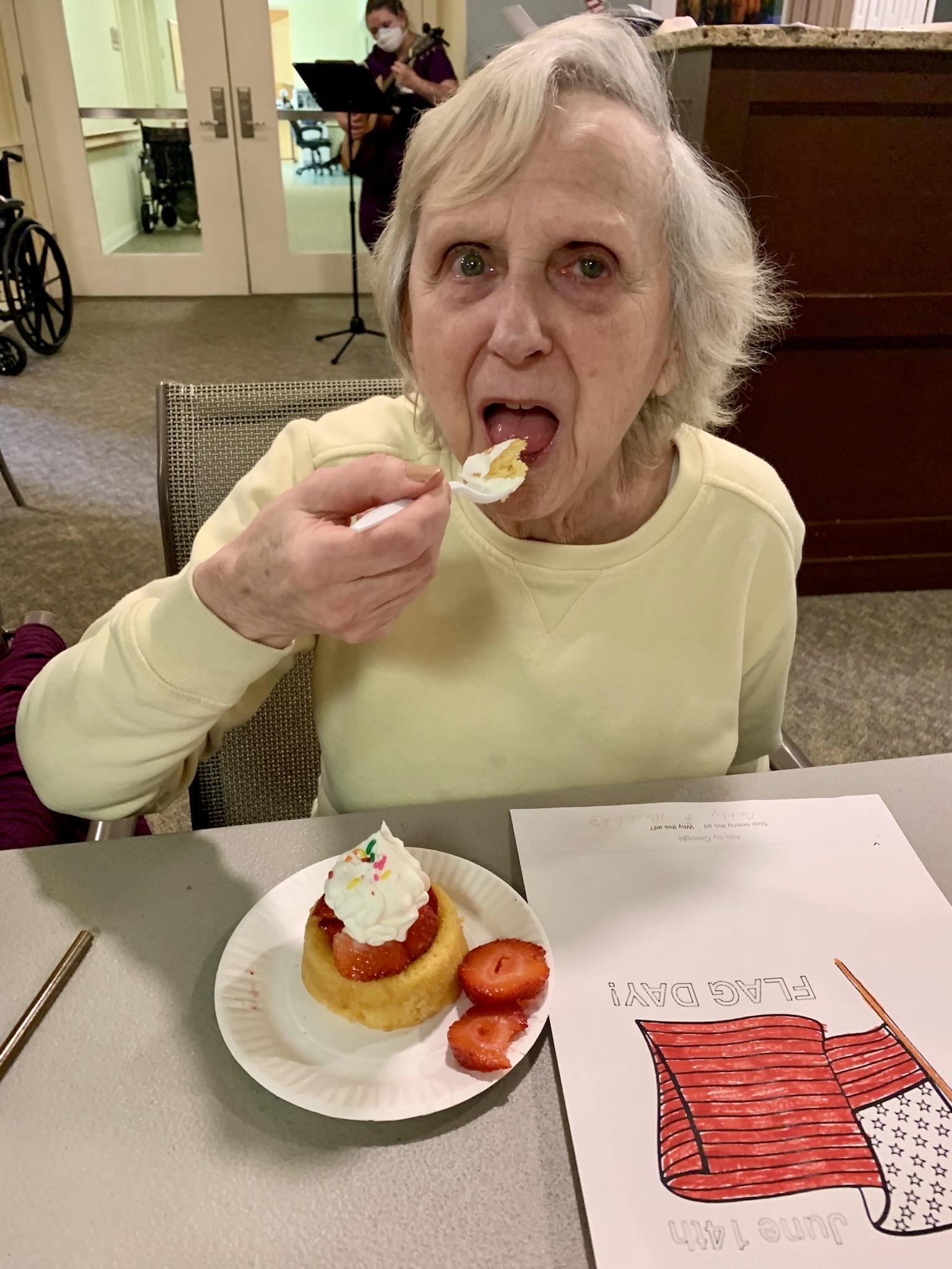 Resident enjoying dessert during a meal activity