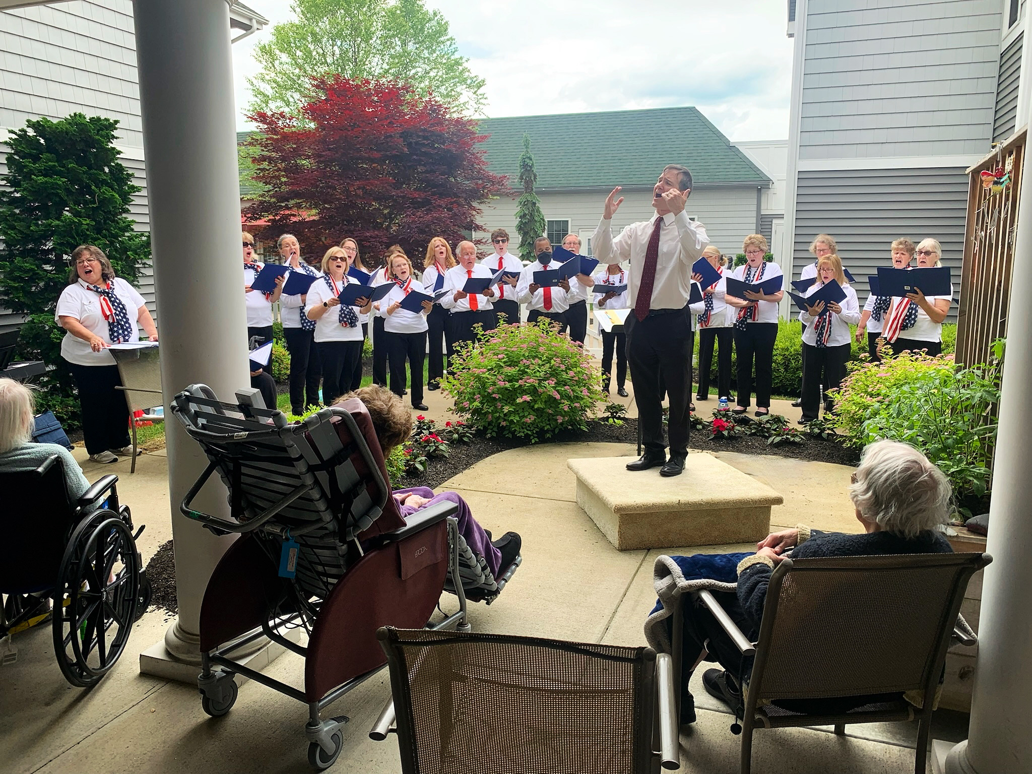 Residents enjoying a choir performance in the garden