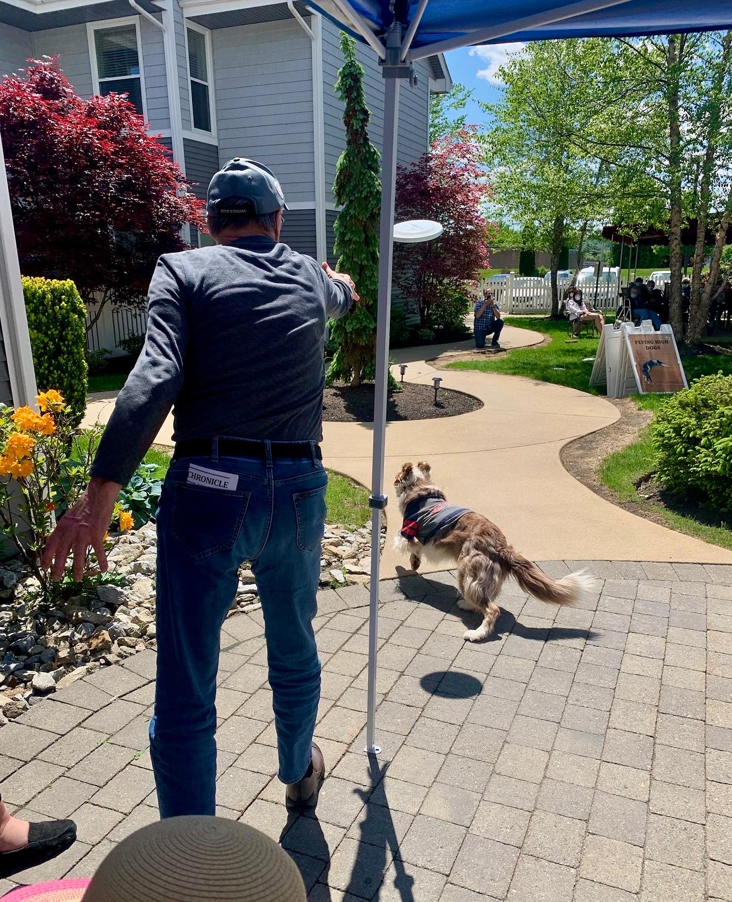 Resident interacting with a dog in a garden area