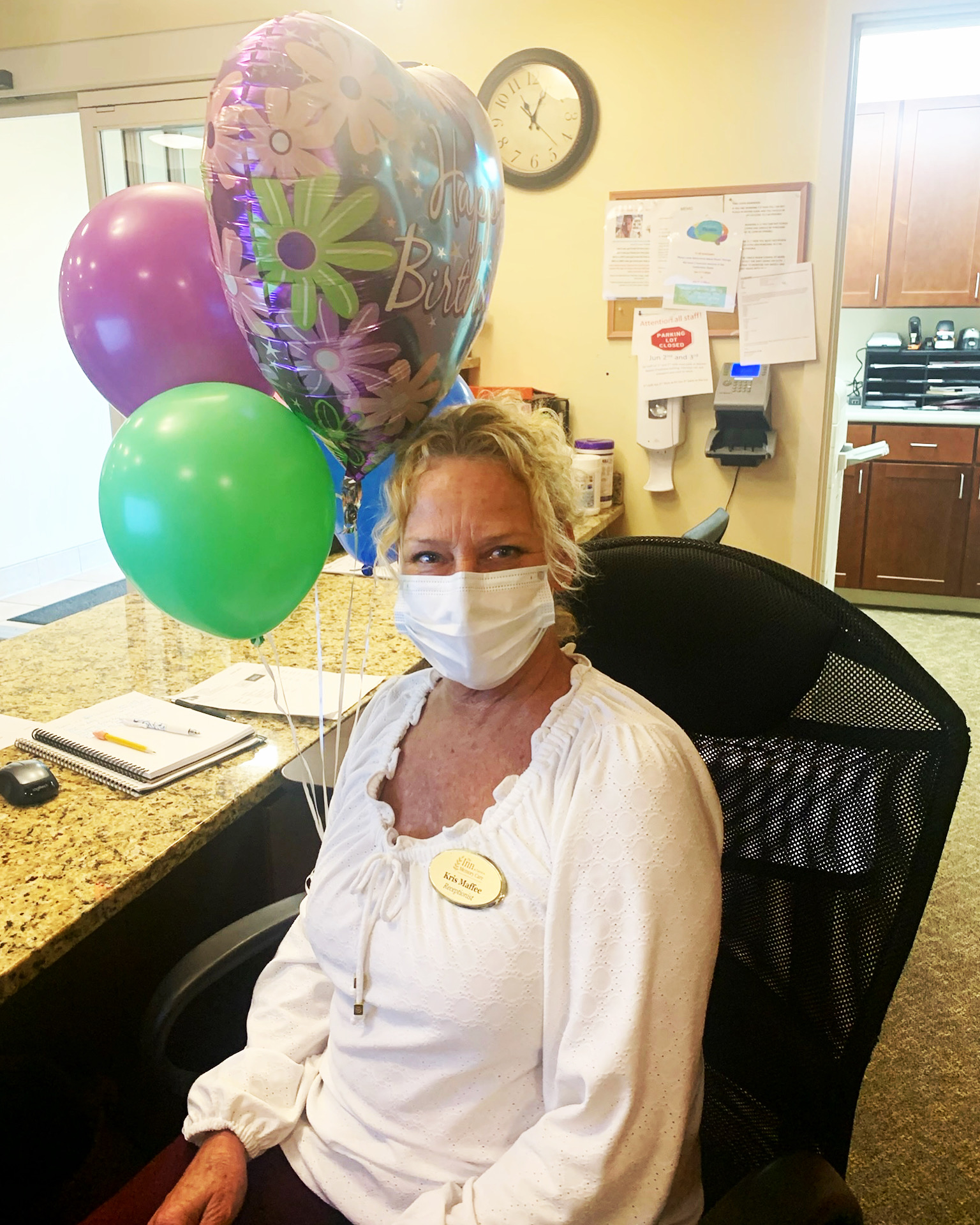 Staff member celebrating a birthday with balloons