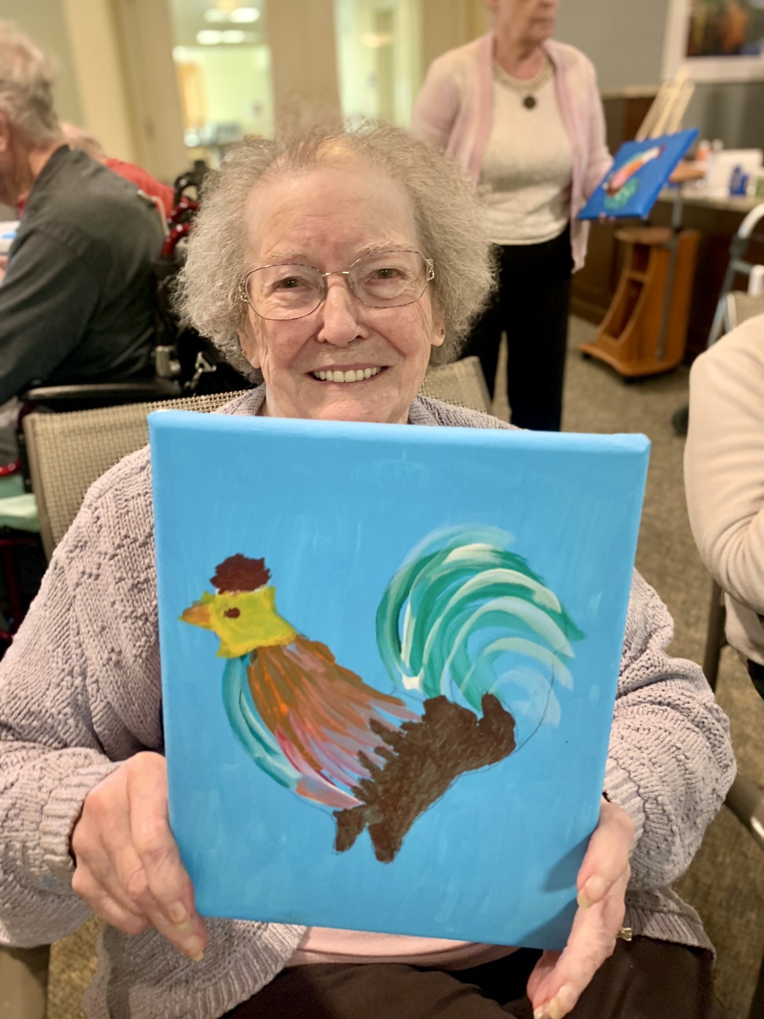 Resident proudly displays a colorful painting