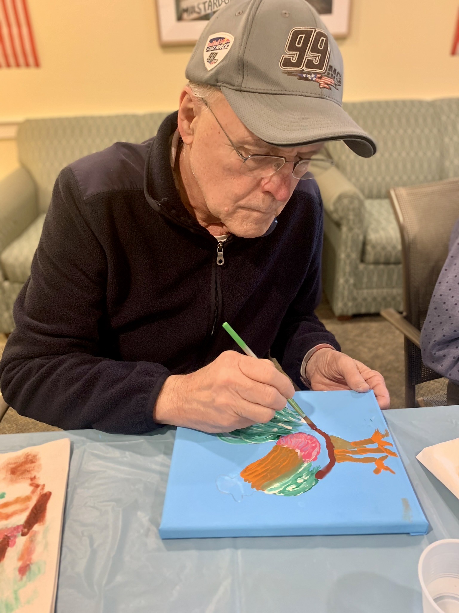 Resident painting during an arts and crafts activity