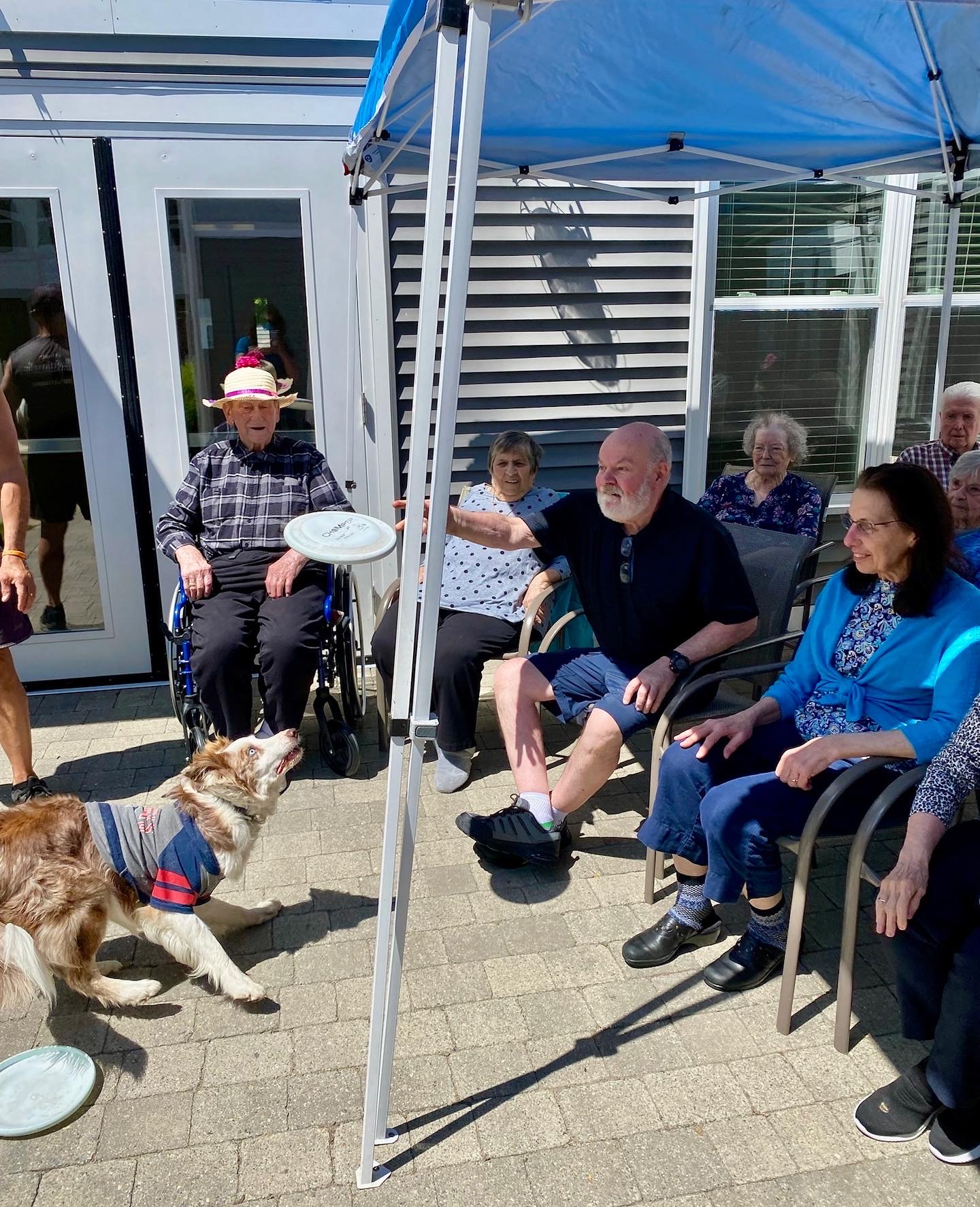 Residents enjoying time with a dog outside