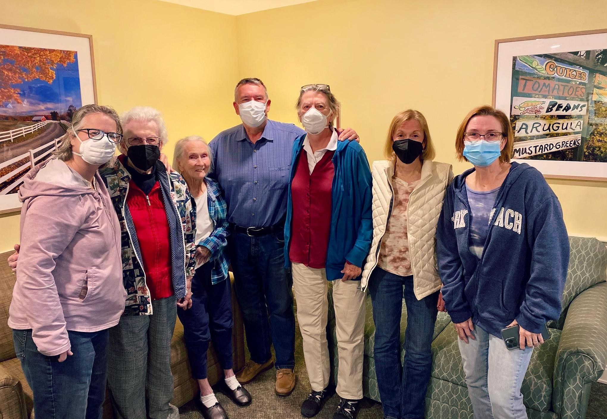 Group of residents and staff posing together indoors