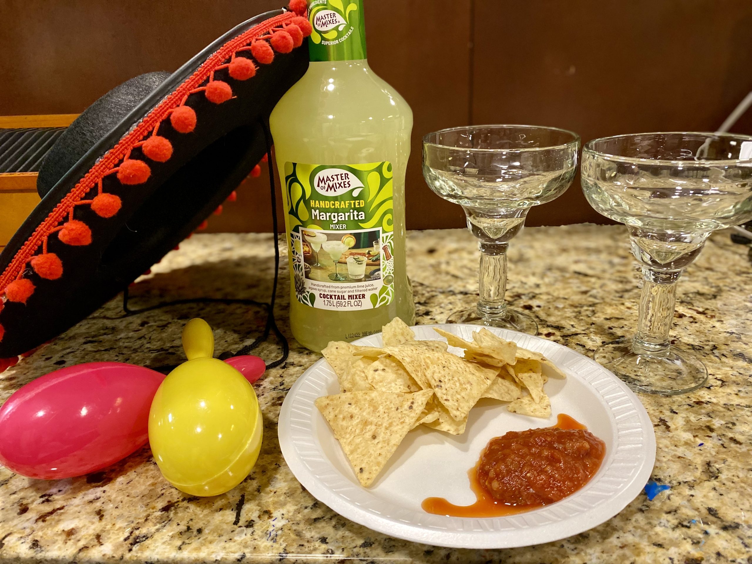 Plate of tortilla chips with salsa and drinks