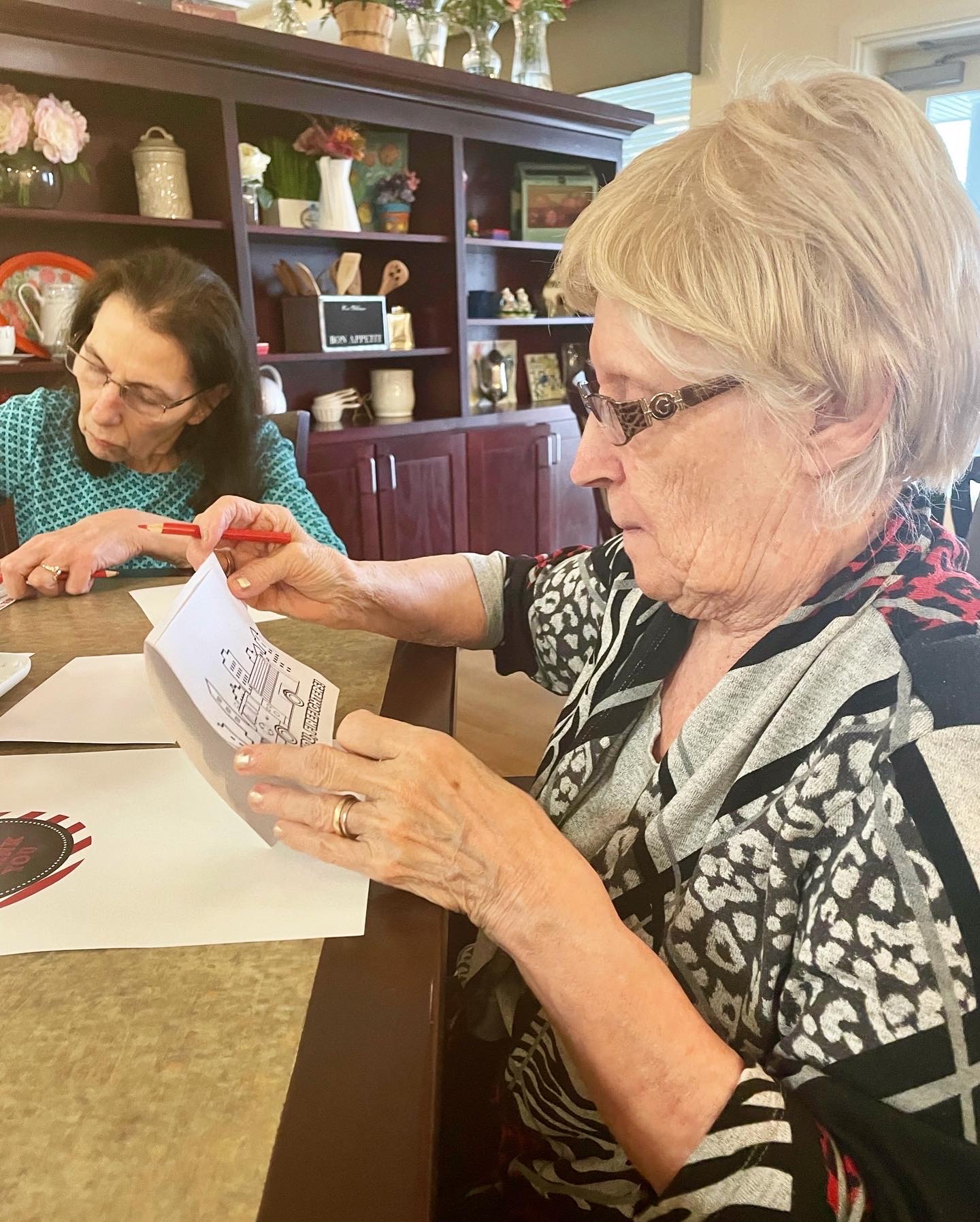 Residents engaged in a craft activity in a common area