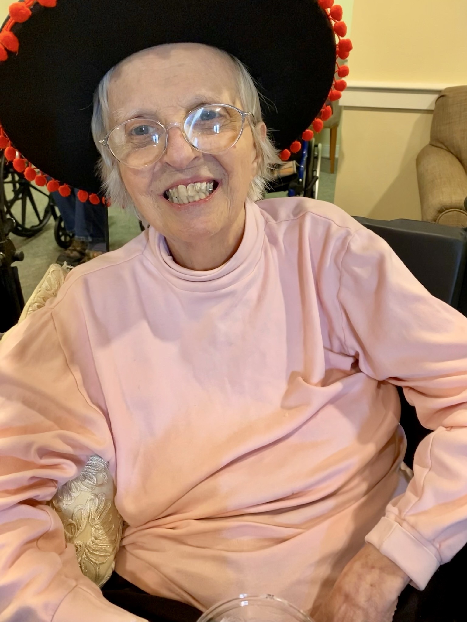 Resident smiling while wearing a decorated hat