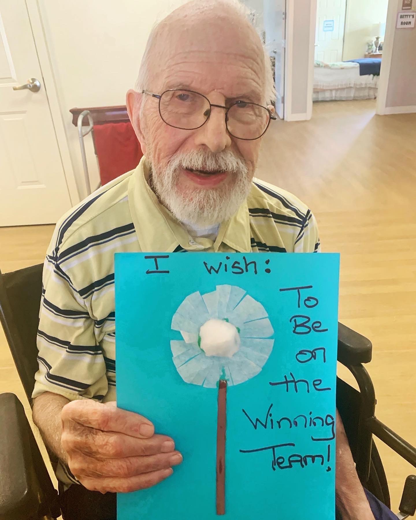 Resident proudly holding a handmade sign