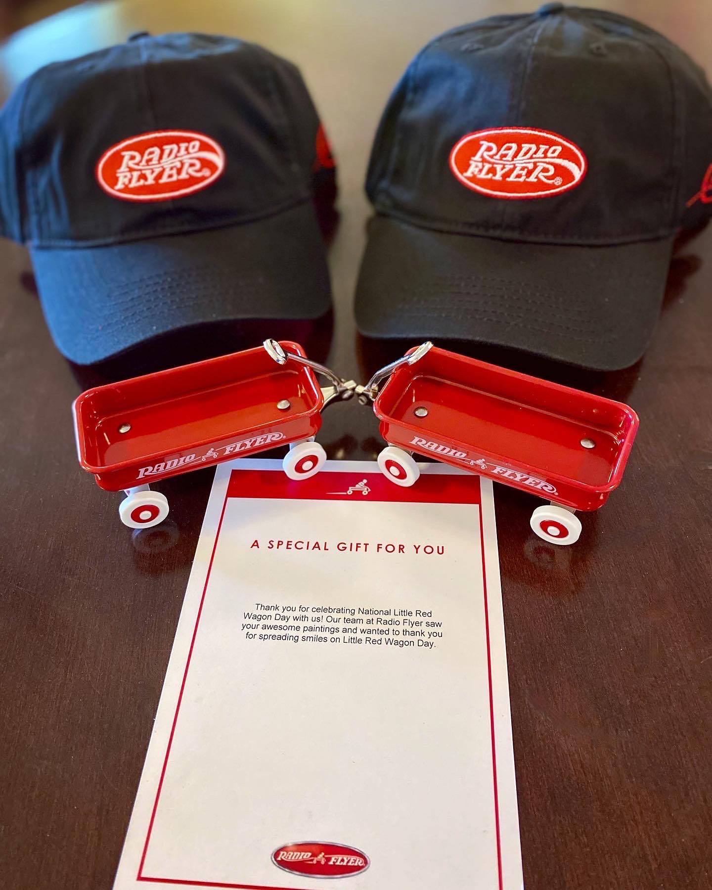 Two hats and red wagons with a note