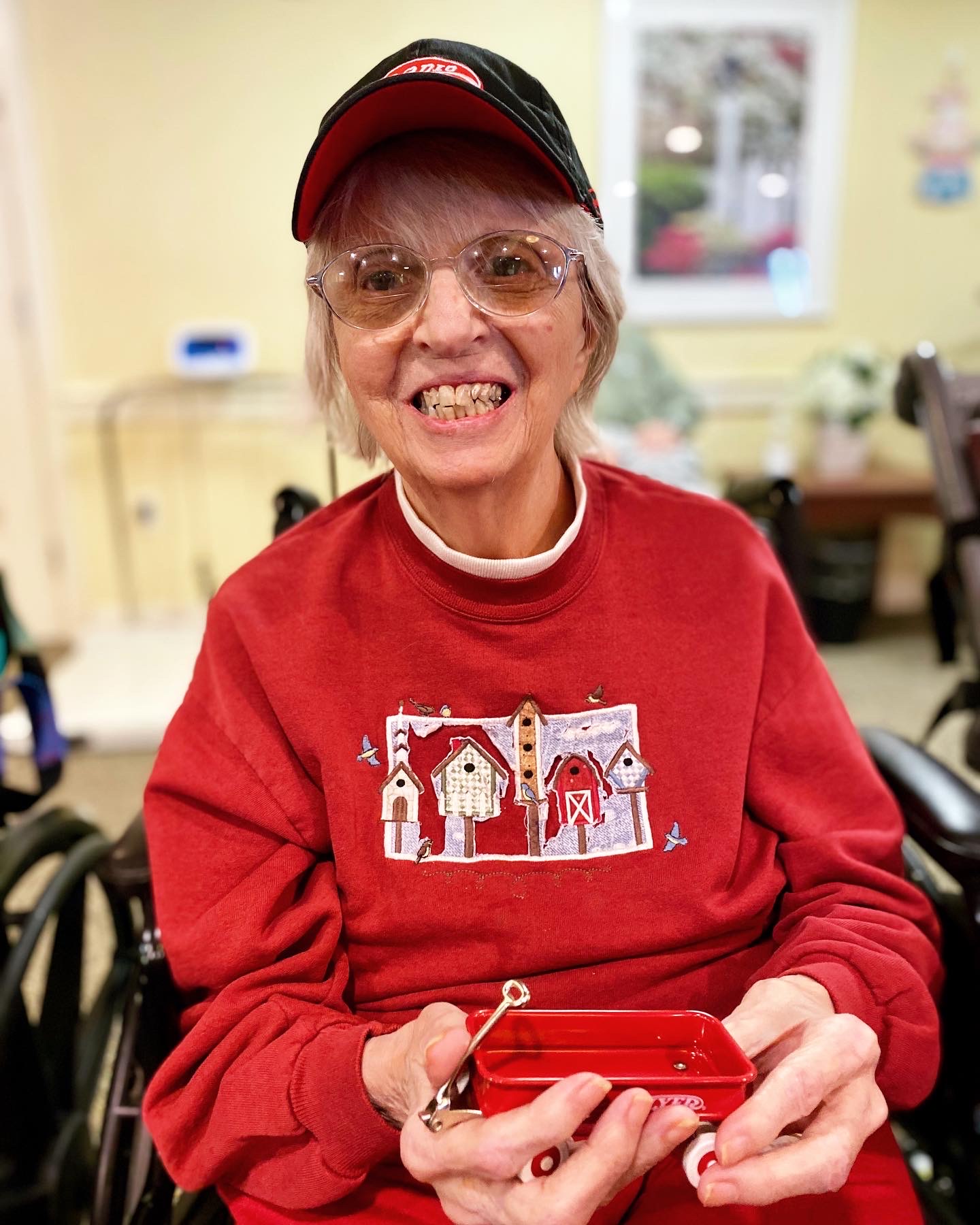 Senior resident smiling while holding a small object