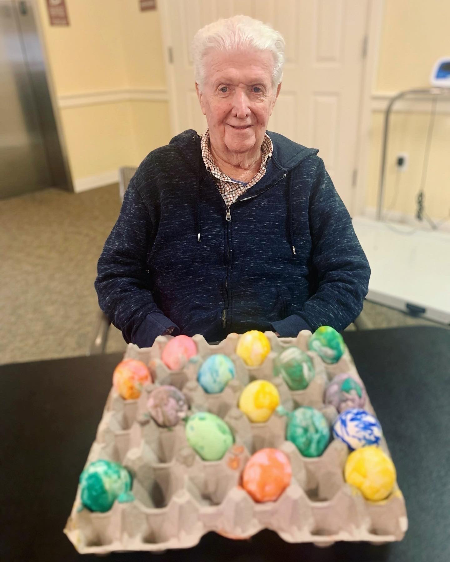 Resident participating in an Easter egg decoration activity