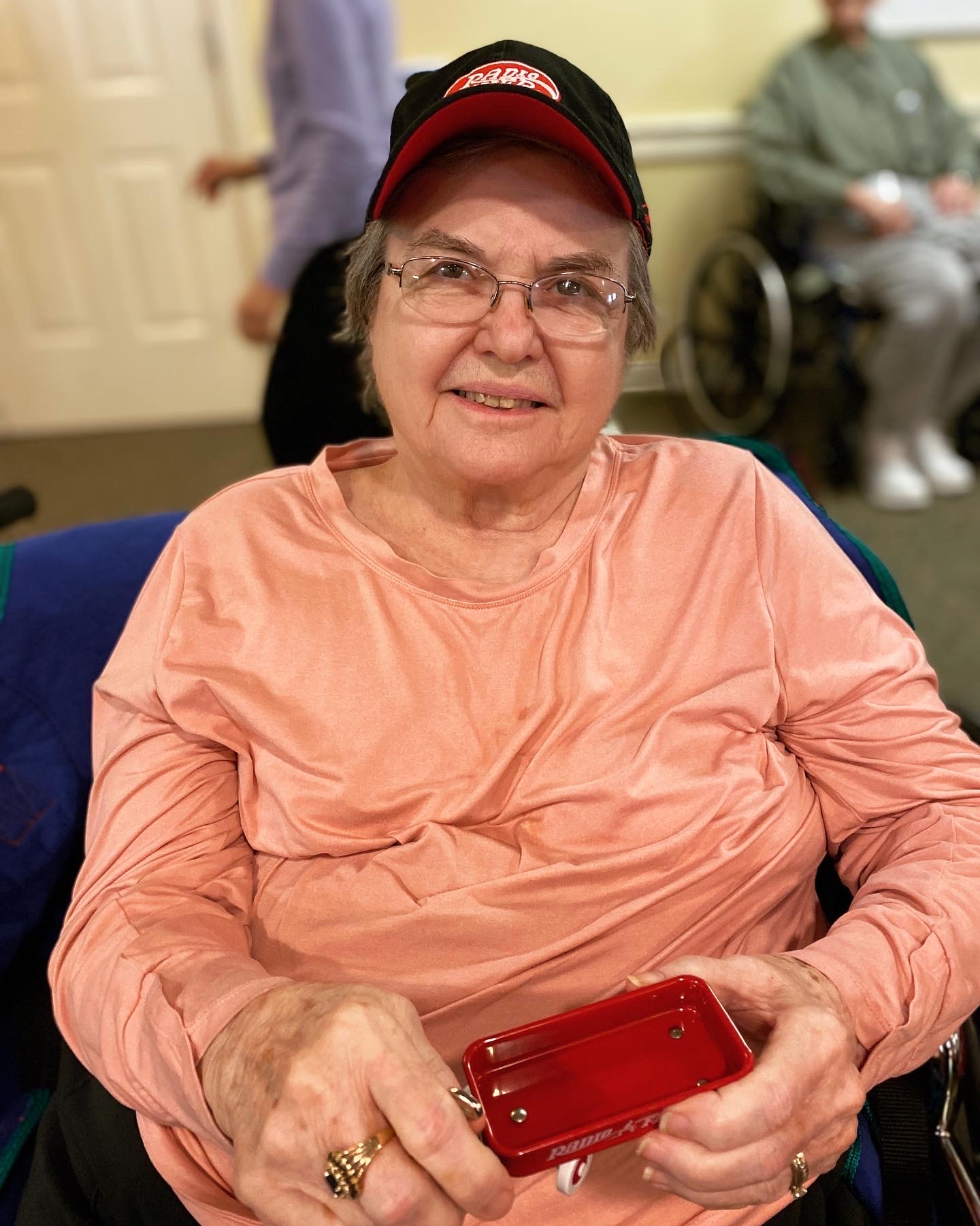 Resident smiling in a common area with activities