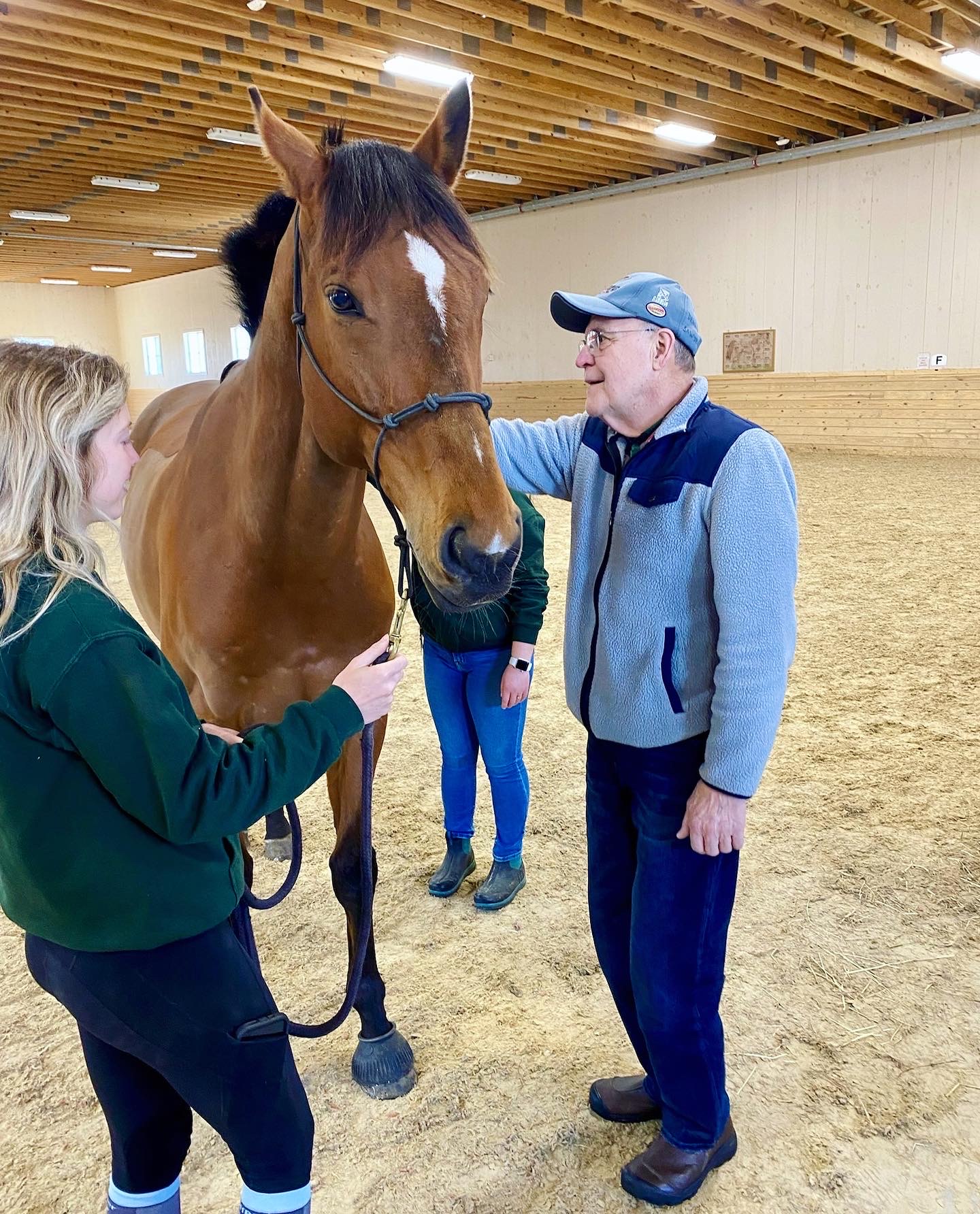 Residents interacting with a horse in a facility activity