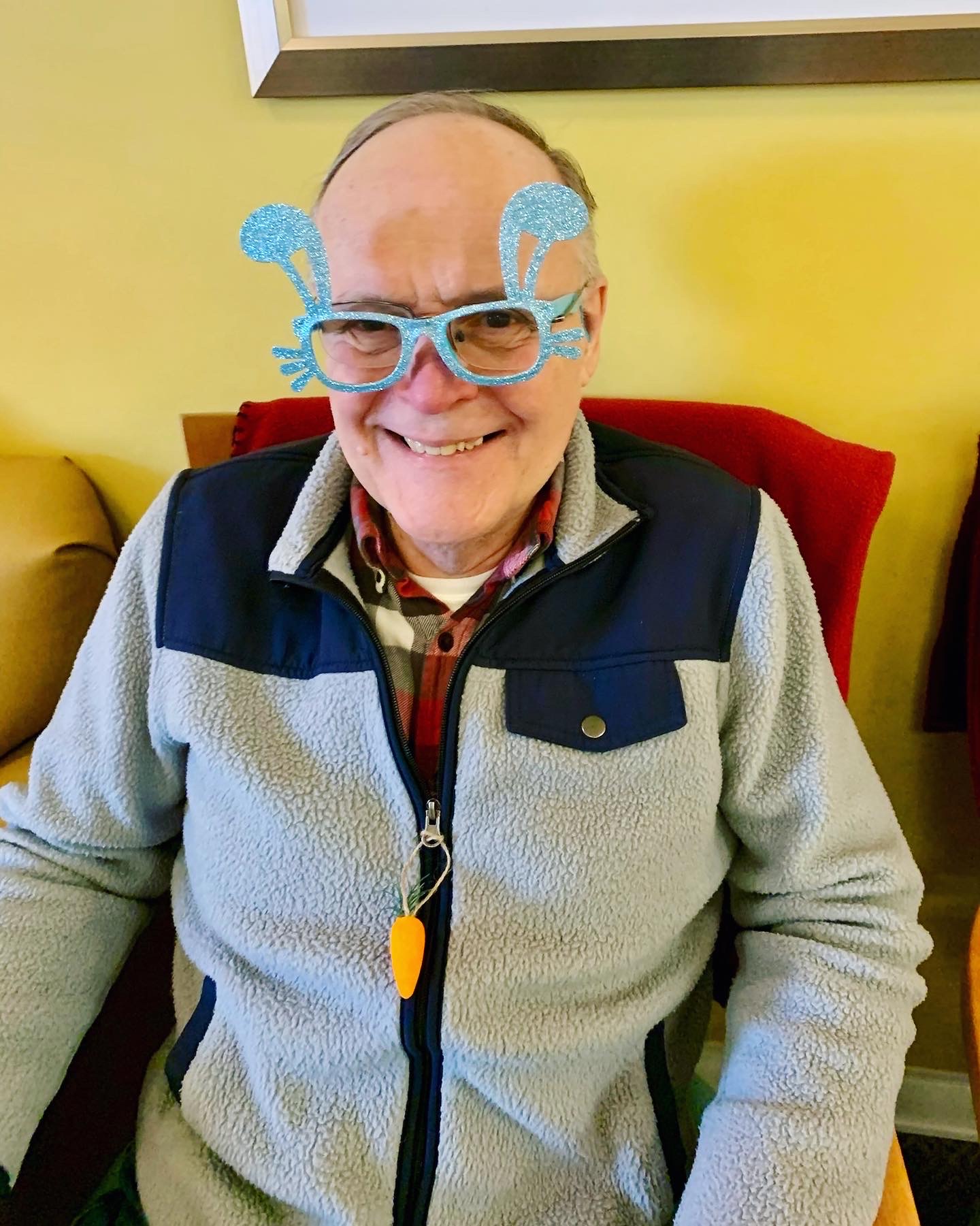 Resident wearing playful glasses in a common area