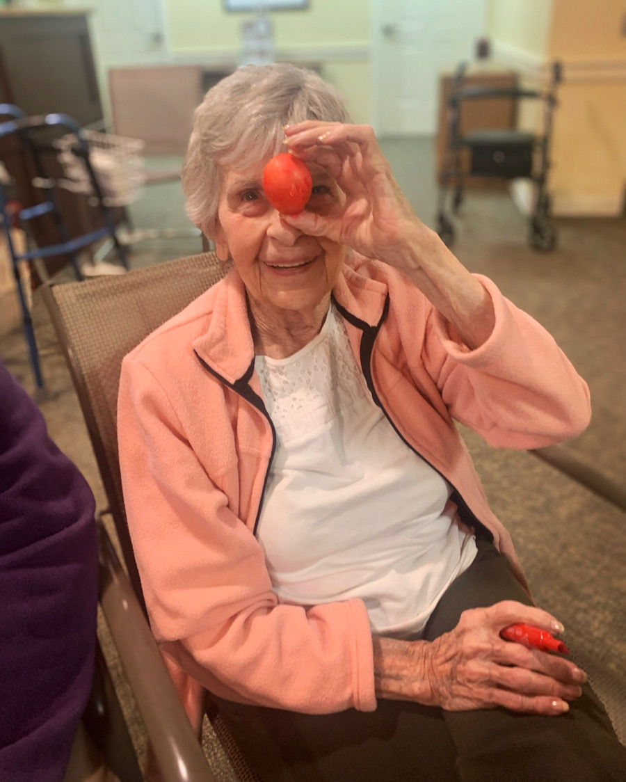 Resident enjoying an activity with a tomato