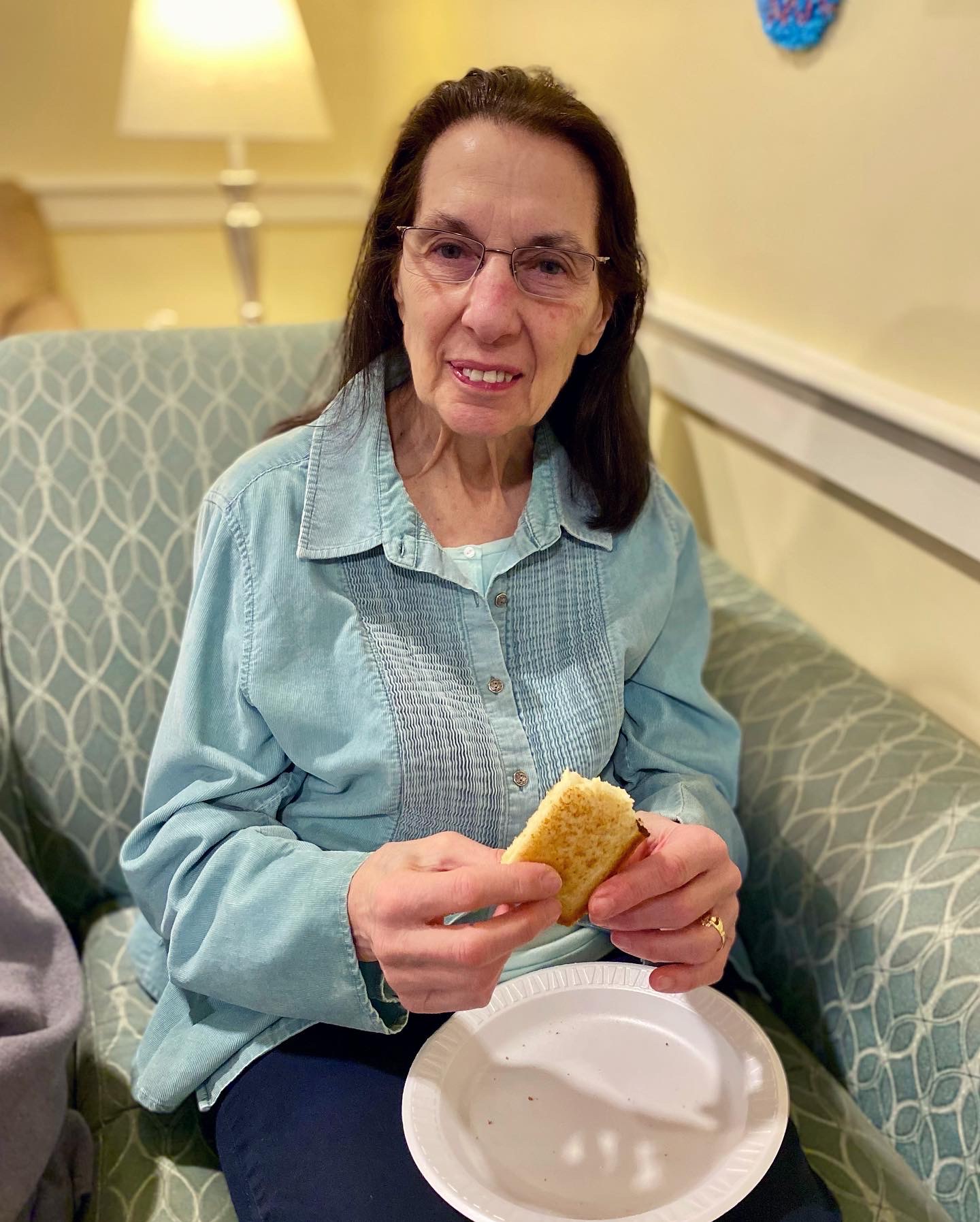 Resident enjoying a snack in a cozy common area