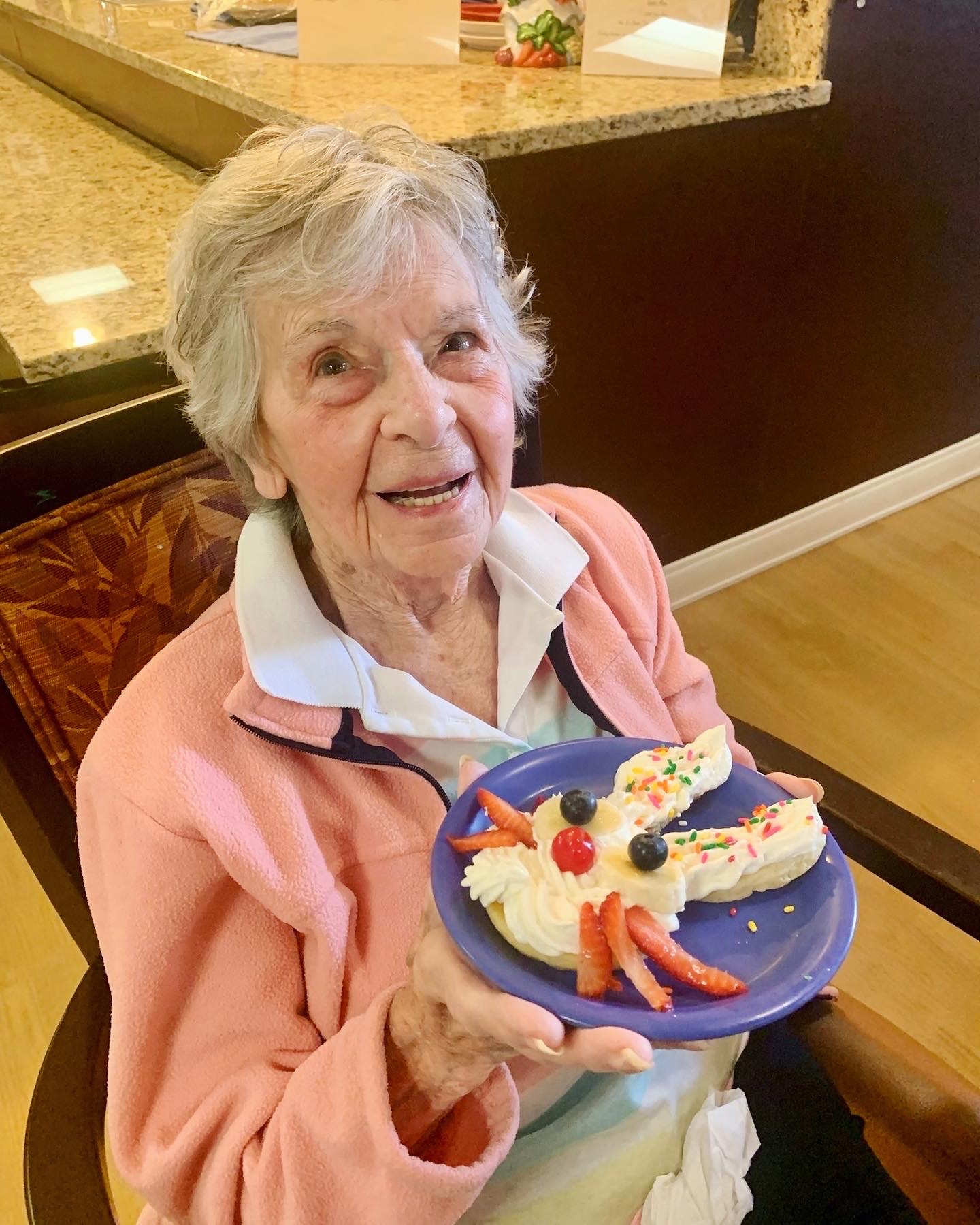 Resident holding a decorative plate of food