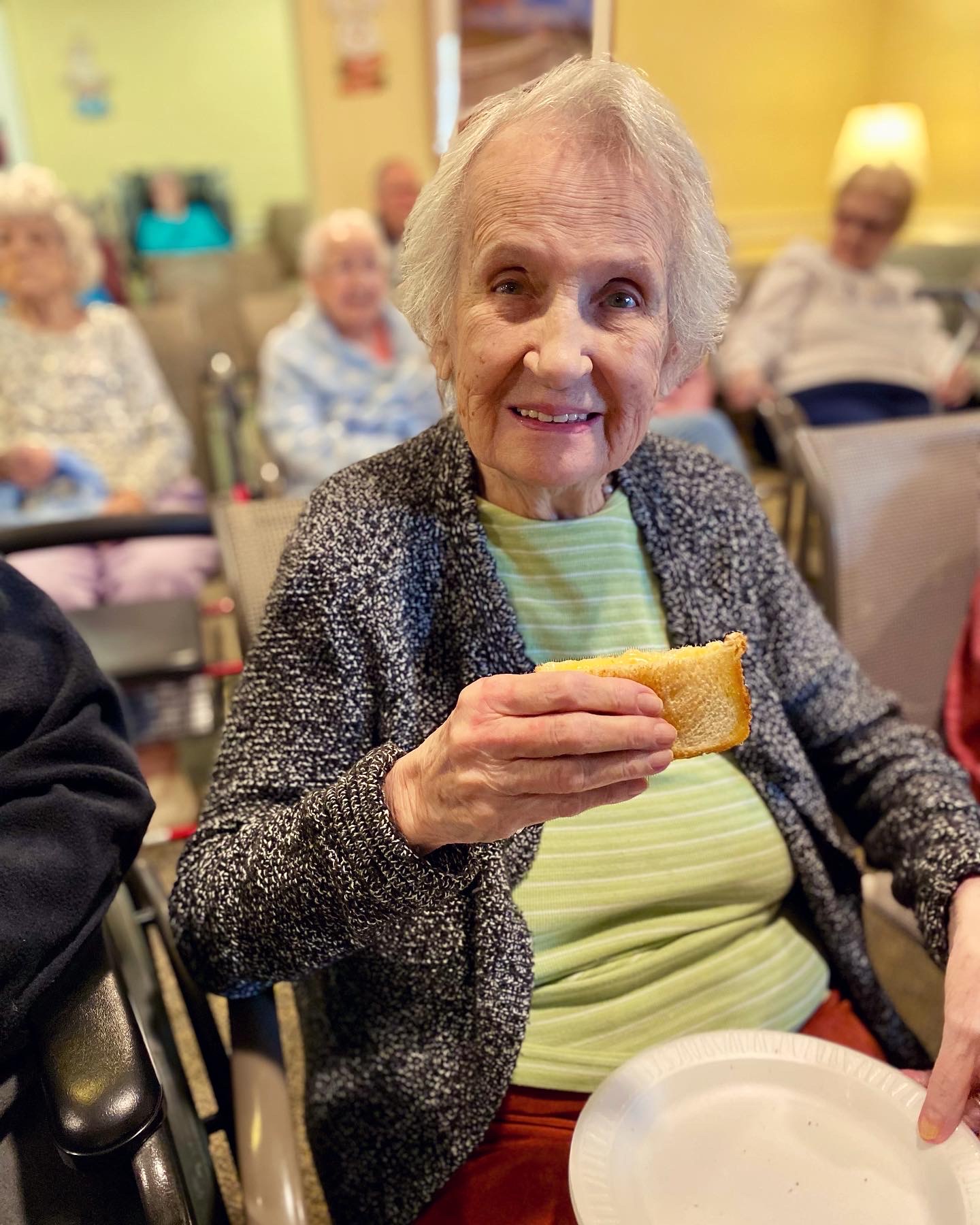 Resident enjoying a sandwich in a common area