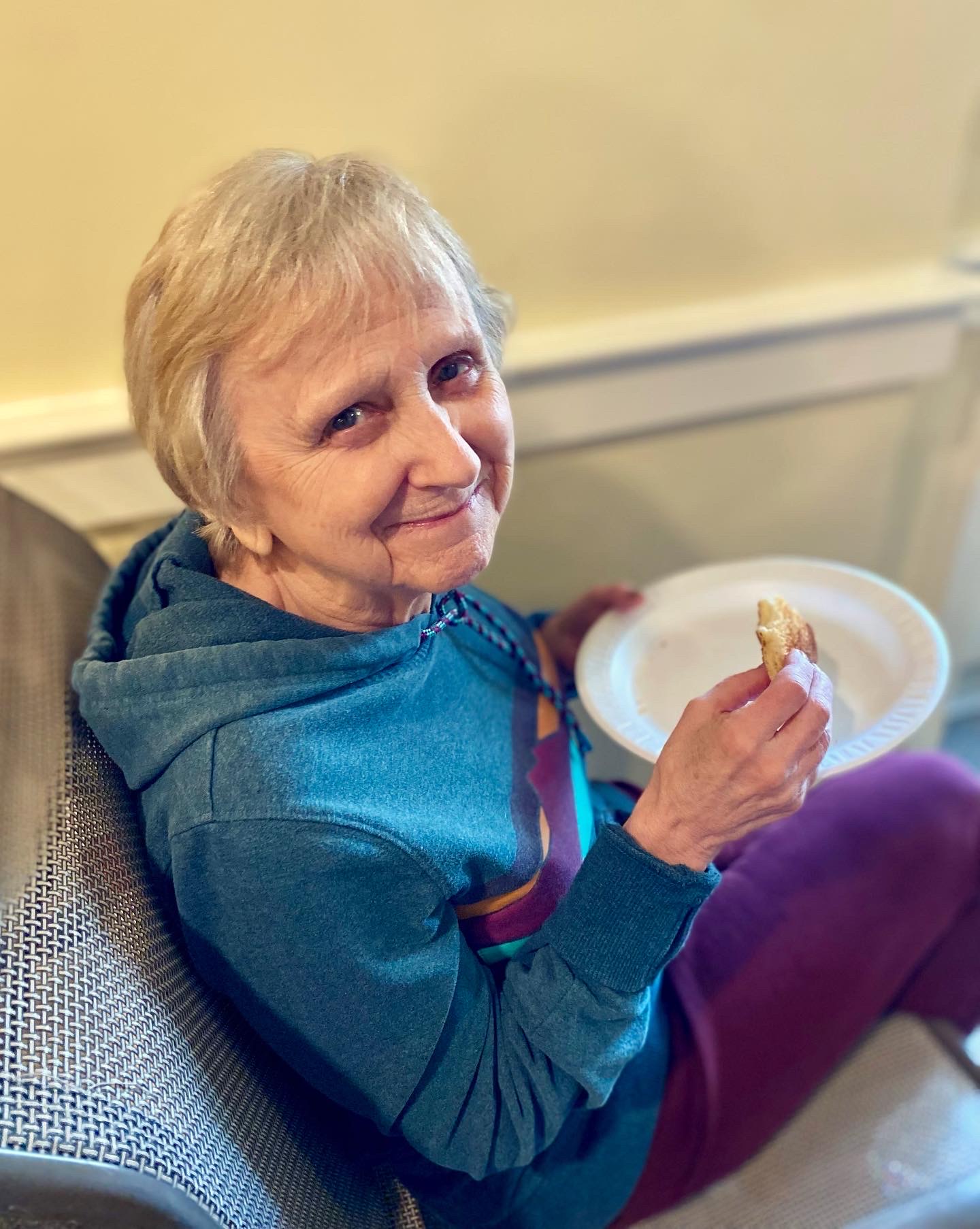 Resident enjoying a meal in the dining area