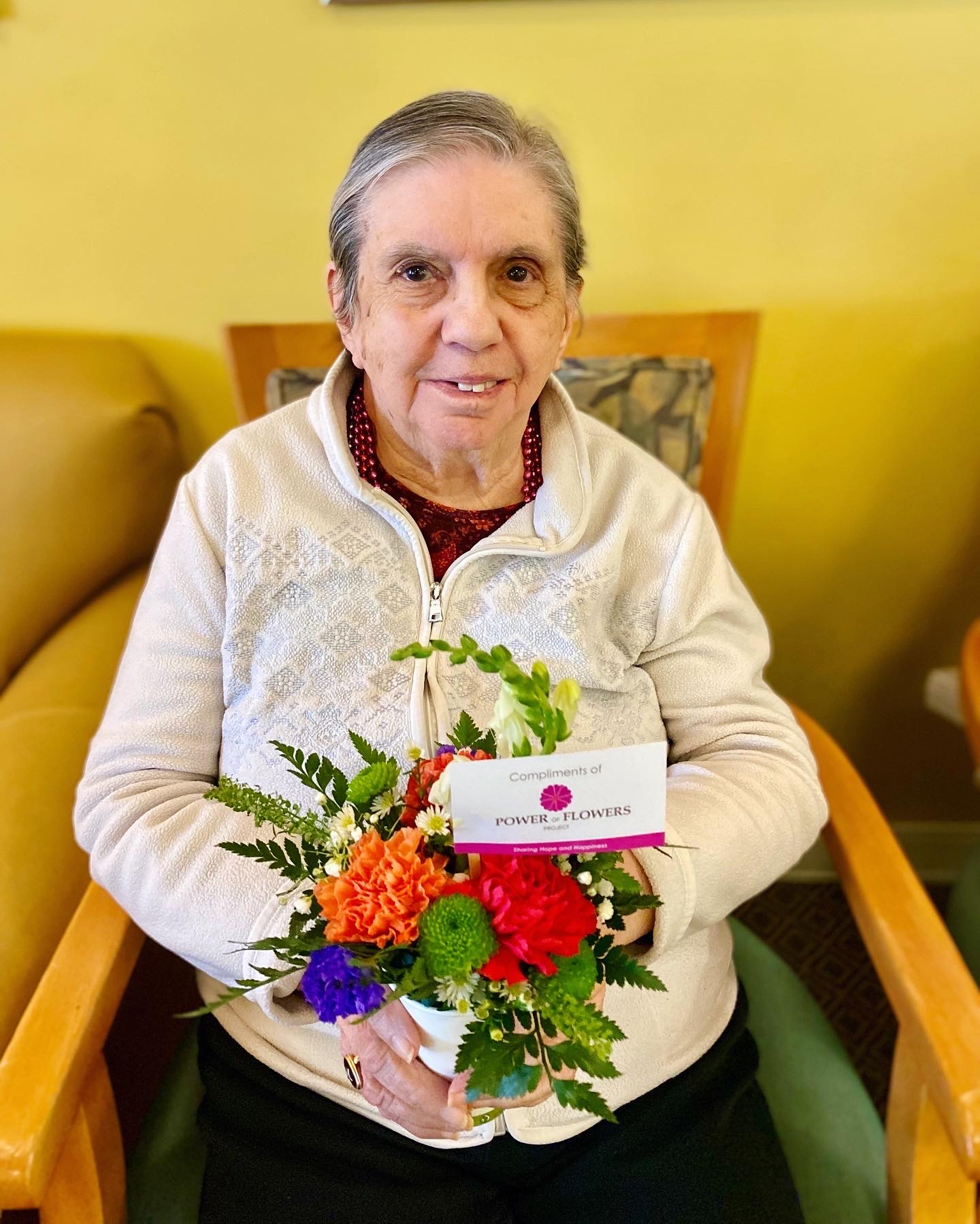 Resident receiving a flower bouquet in a common area