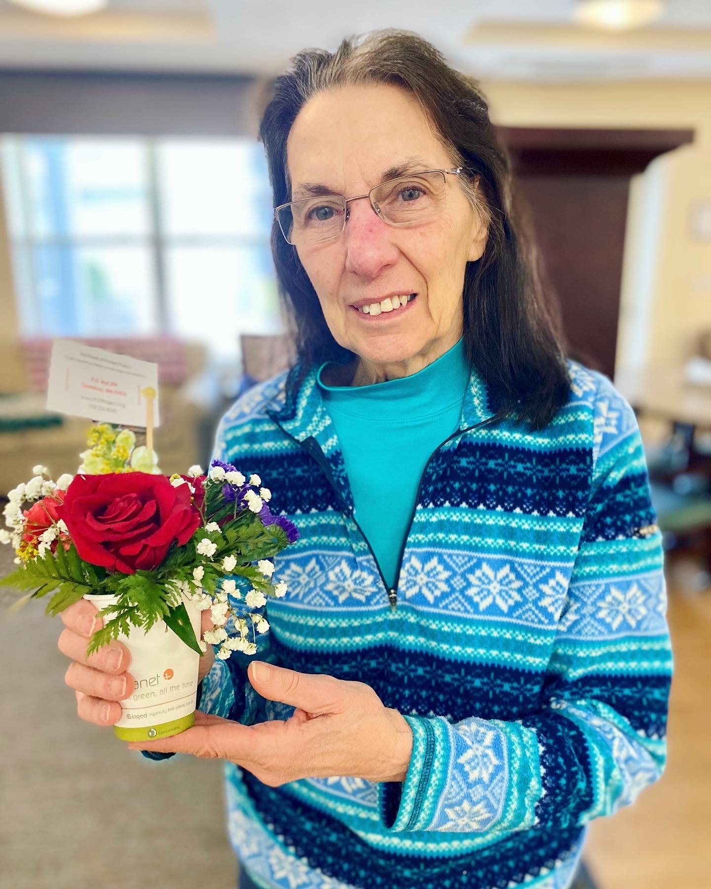 Resident holding a flower bouquet in a common area
