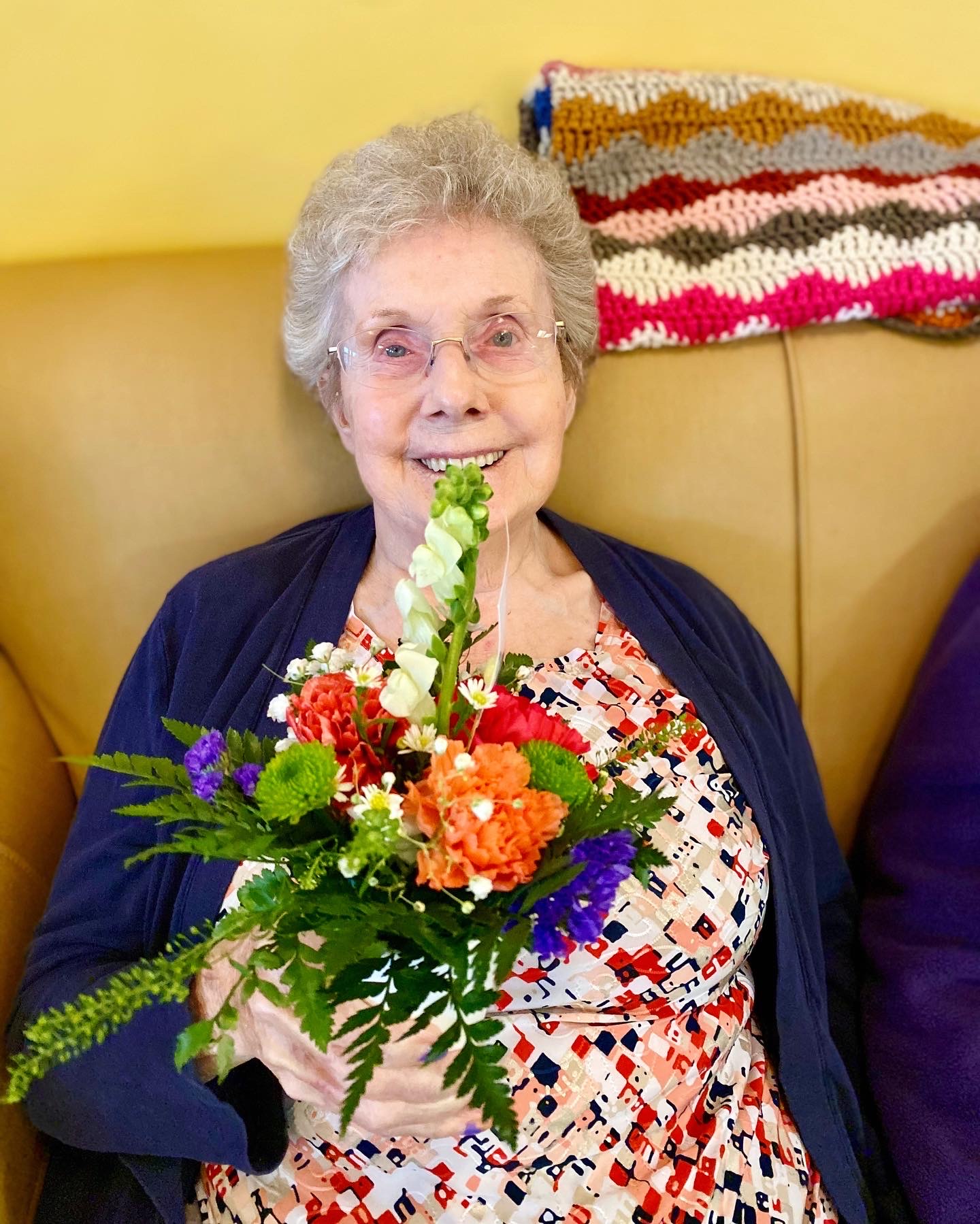 Resident holding a flower bouquet in a common area
