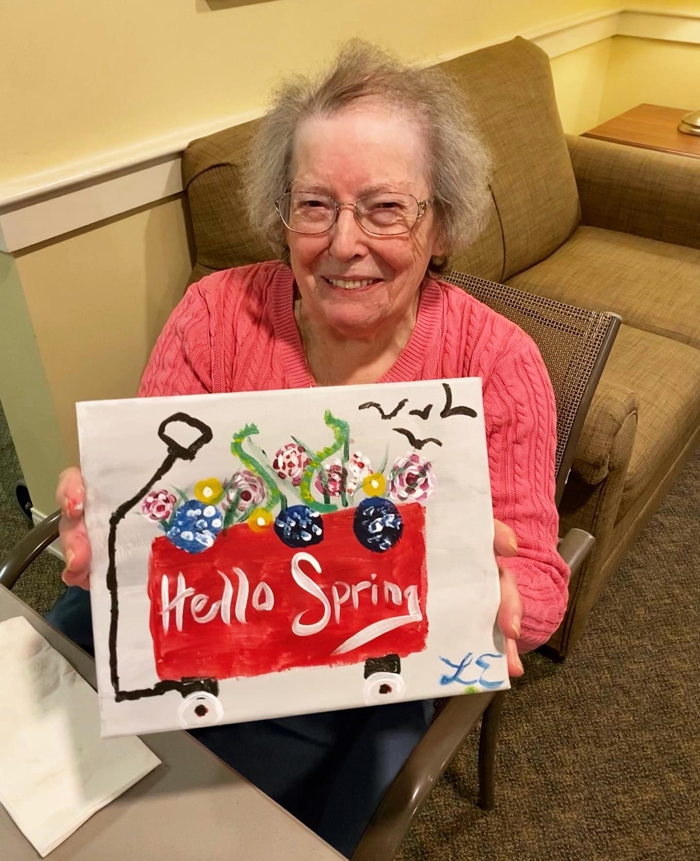 Resident proudly displaying a spring painting