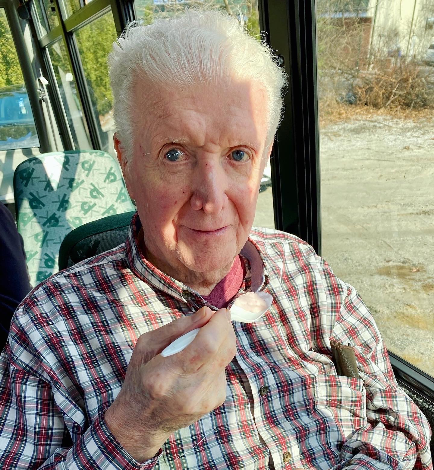 A resident enjoying ice cream on a facility van
