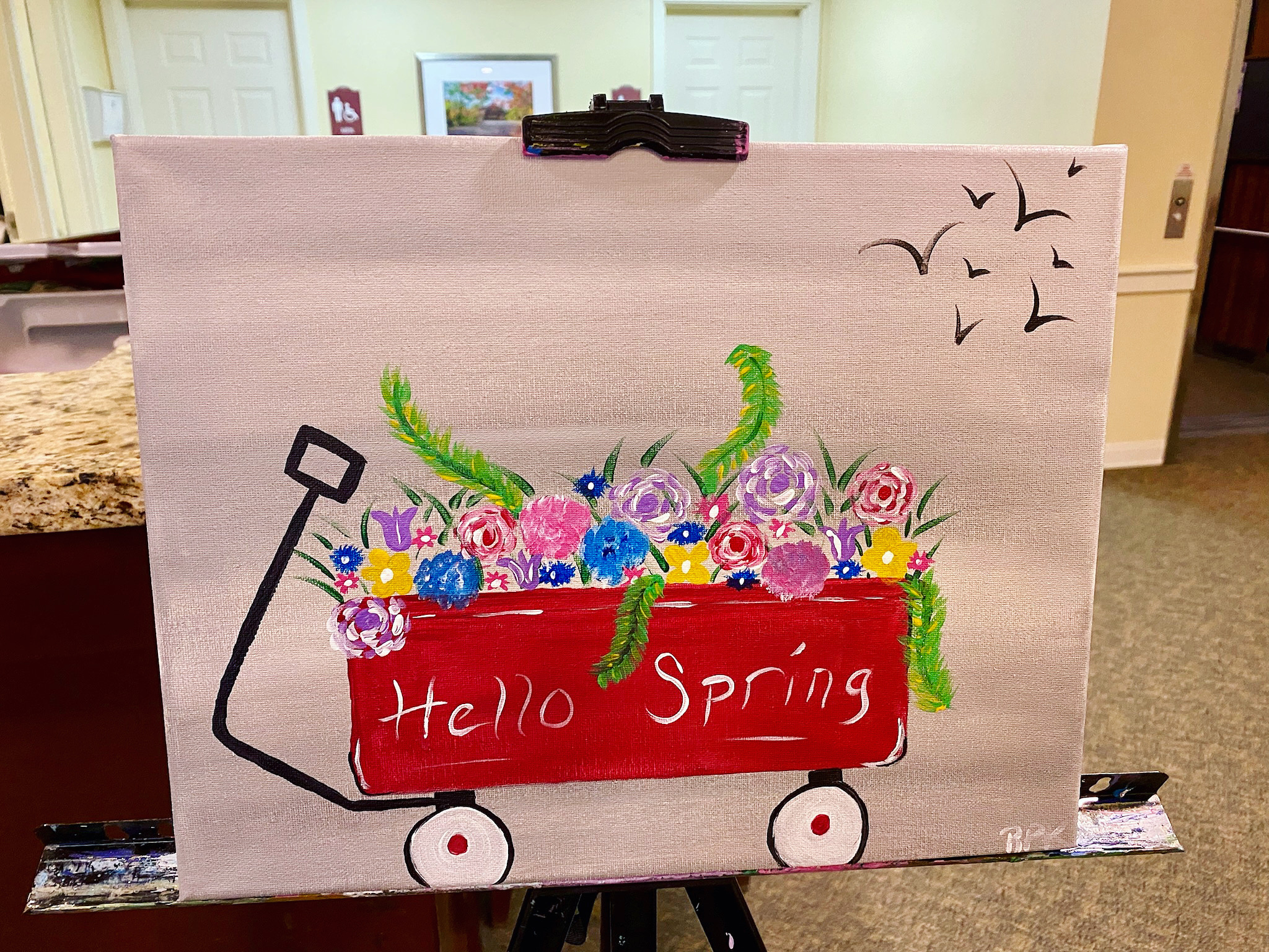 Canvas artwork depicting a spring-themed wagon filled with flowers