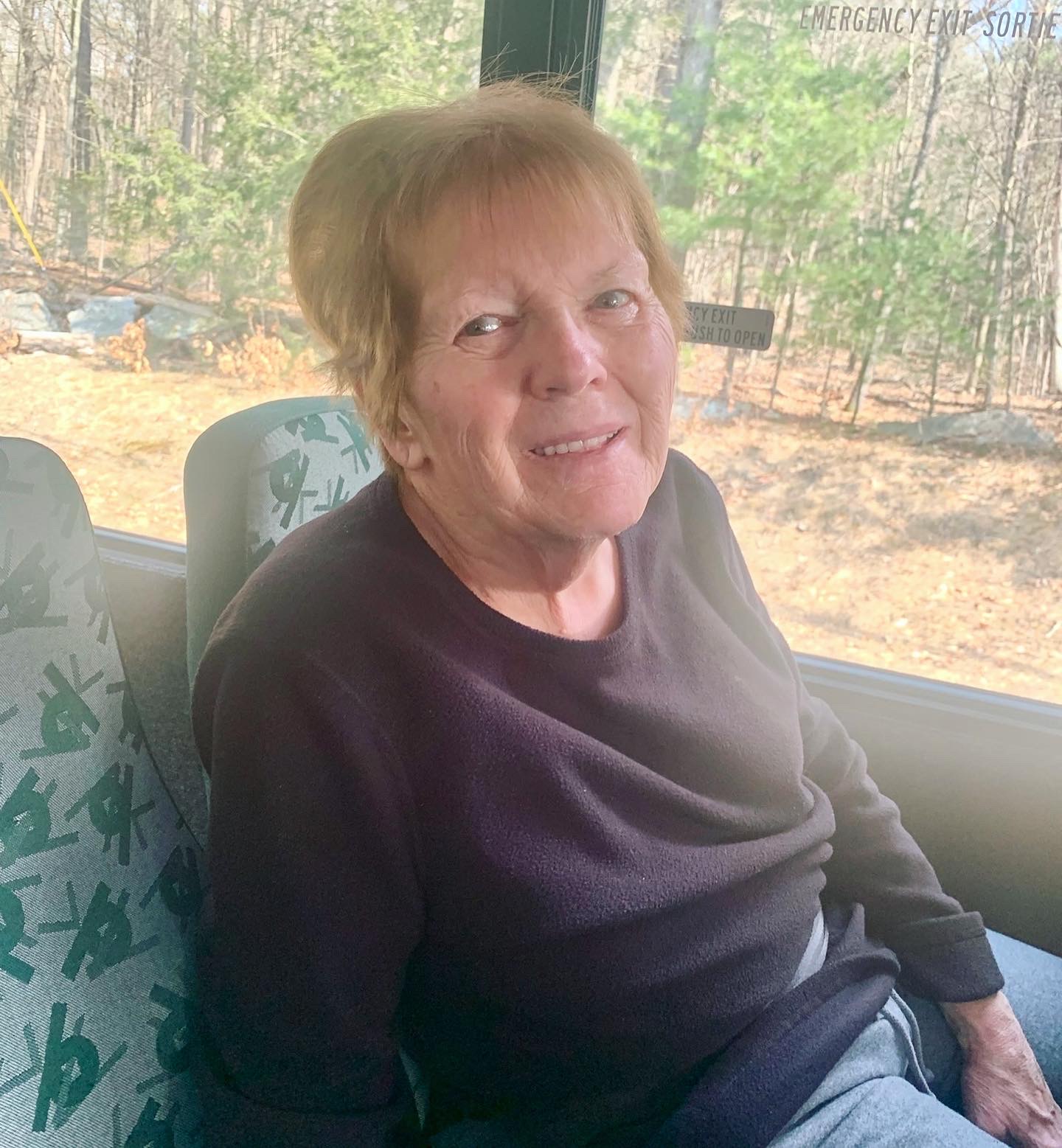 Resident smiling inside a facility vehicle